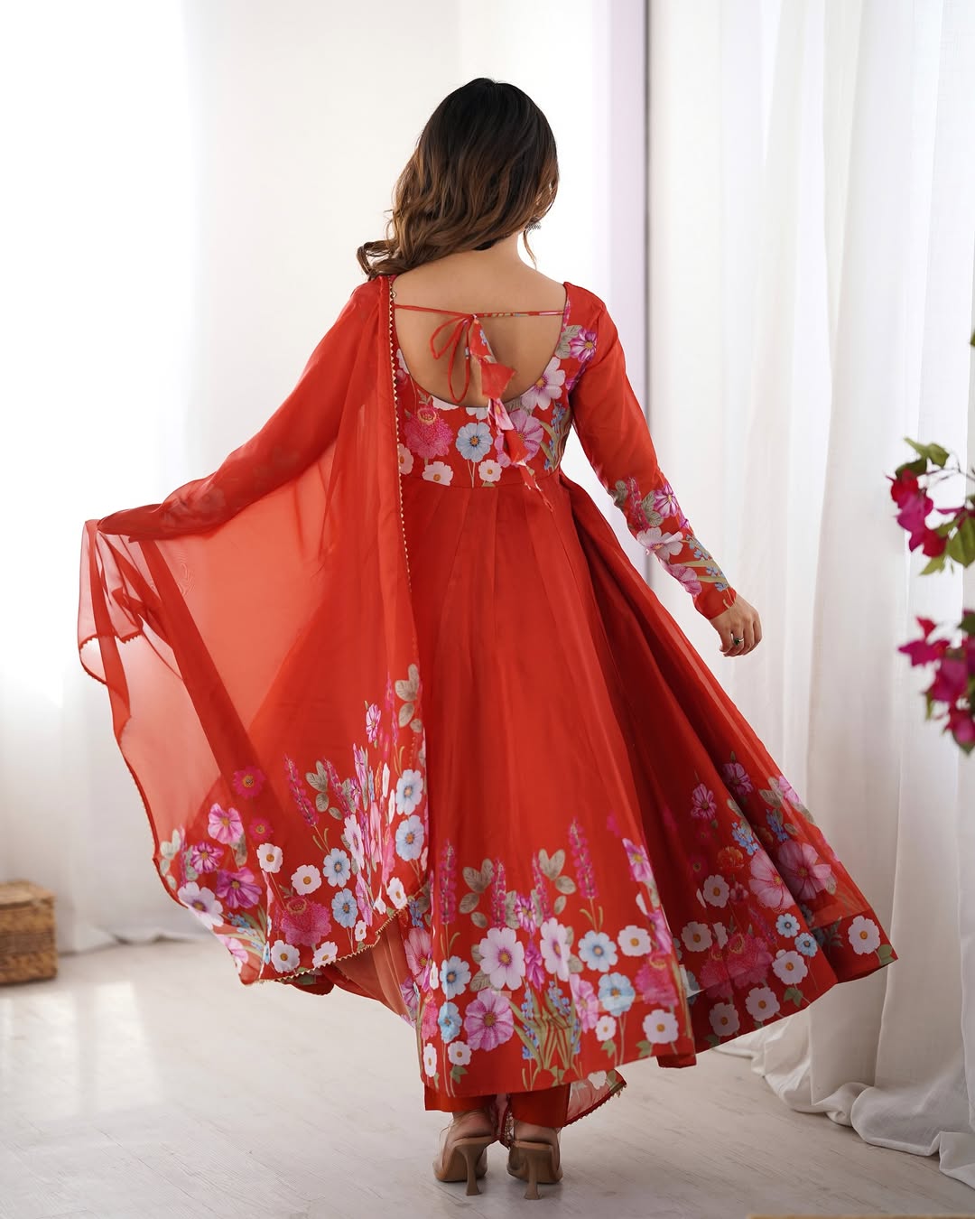Darshika Orange Organza Floral Printed Anarkali Suit Set – fully stitched 4+ meter flared Anarkali in soft organza silk with badla zari and floral print work, paired with micro cotton pant and matching organza dupatta featuring gota patti lace; perfect ethnic outfit for weddings, festivals, and traditional occasions.