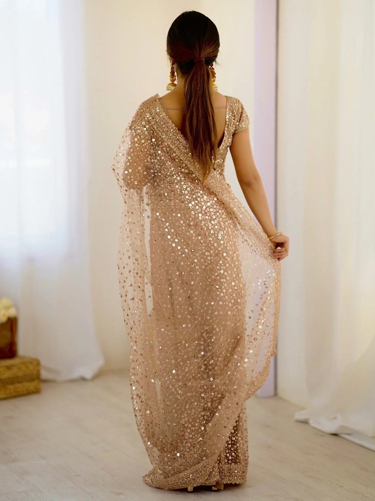 Golden net saree with sequins embroidery and blouse