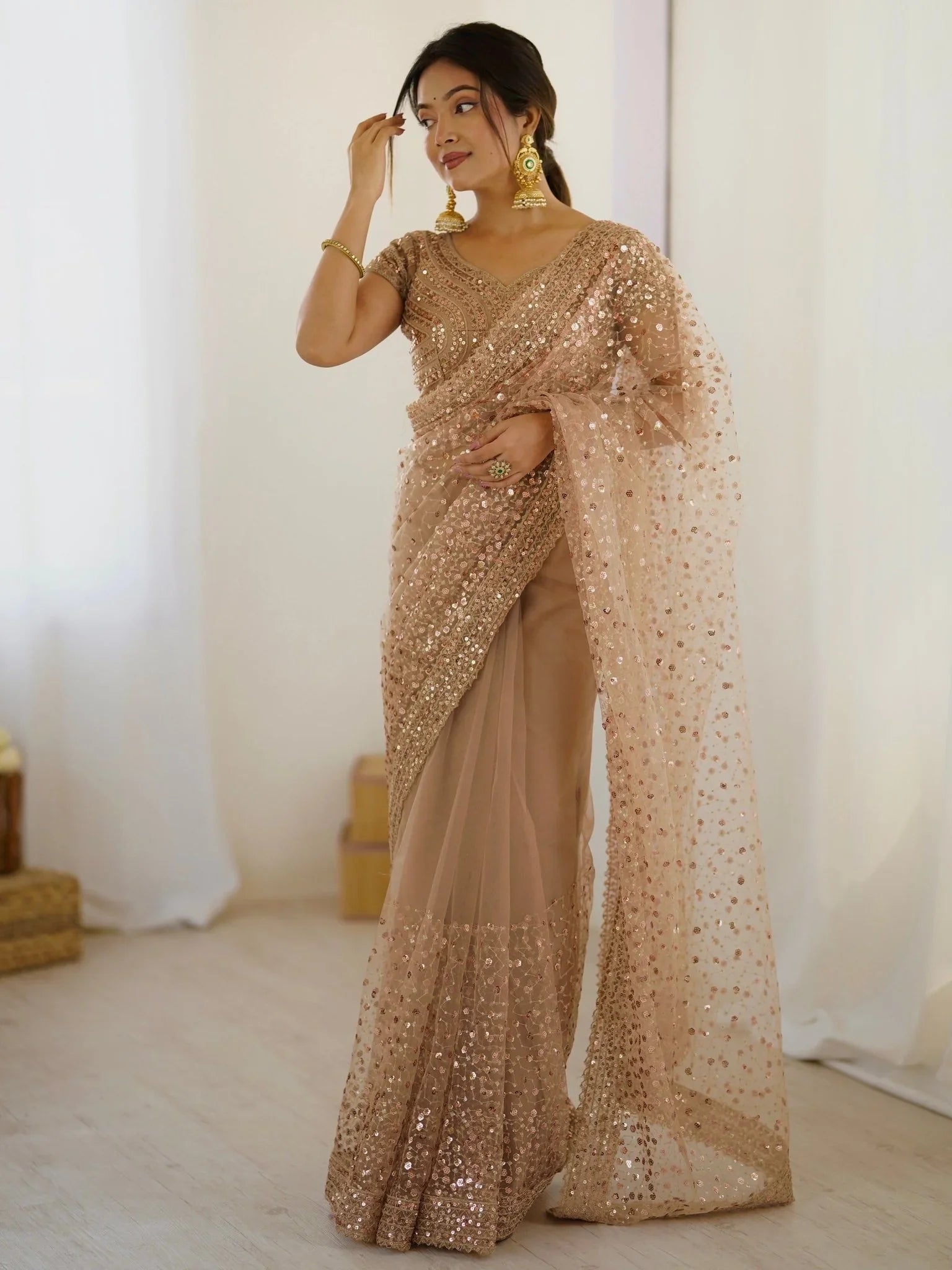 Golden net saree with sequins embroidery and blouse