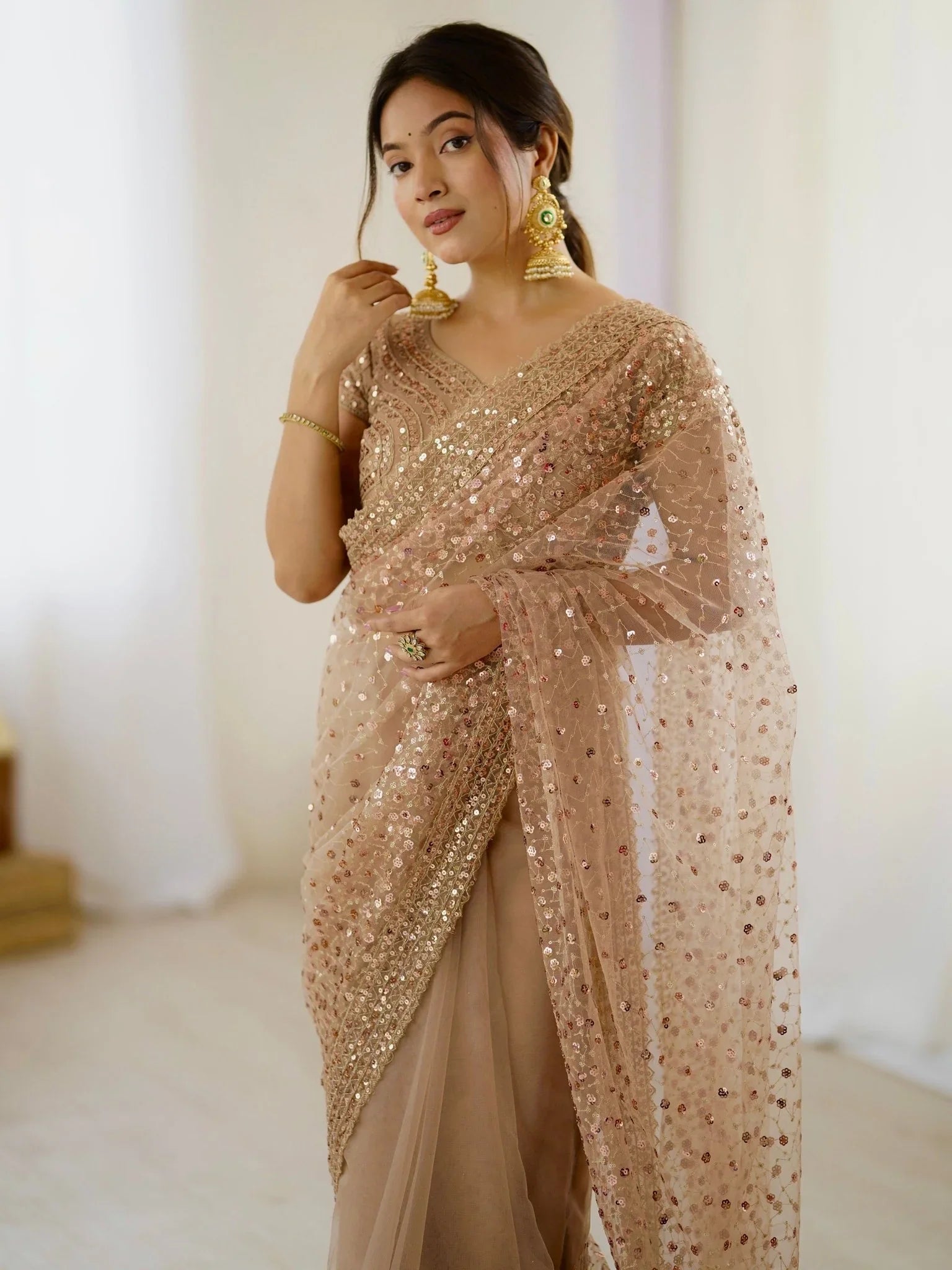 Golden net saree with sequins embroidery and blouse