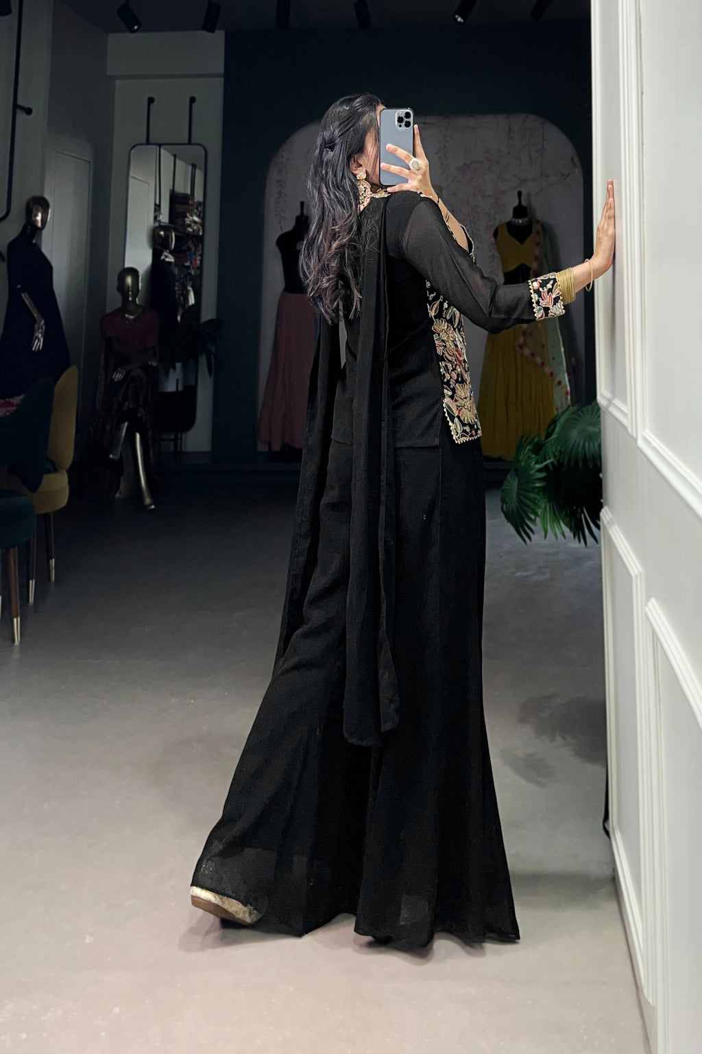 Kanvika Black Kurta Palazzo Set crafted from premium georgette fabric, featuring a short embroidered kurta with sequins and thread embroidery, full sleeves, and a soft micro cotton lining. Paired with plain georgette palazzo pants with an elastic waistband for comfort and a lightweight embroidered georgette dupatta. Ideal for festive wear, party wear, and wedding functions, this elegant ethnic ensemble blends tradition with contemporary sophistication
