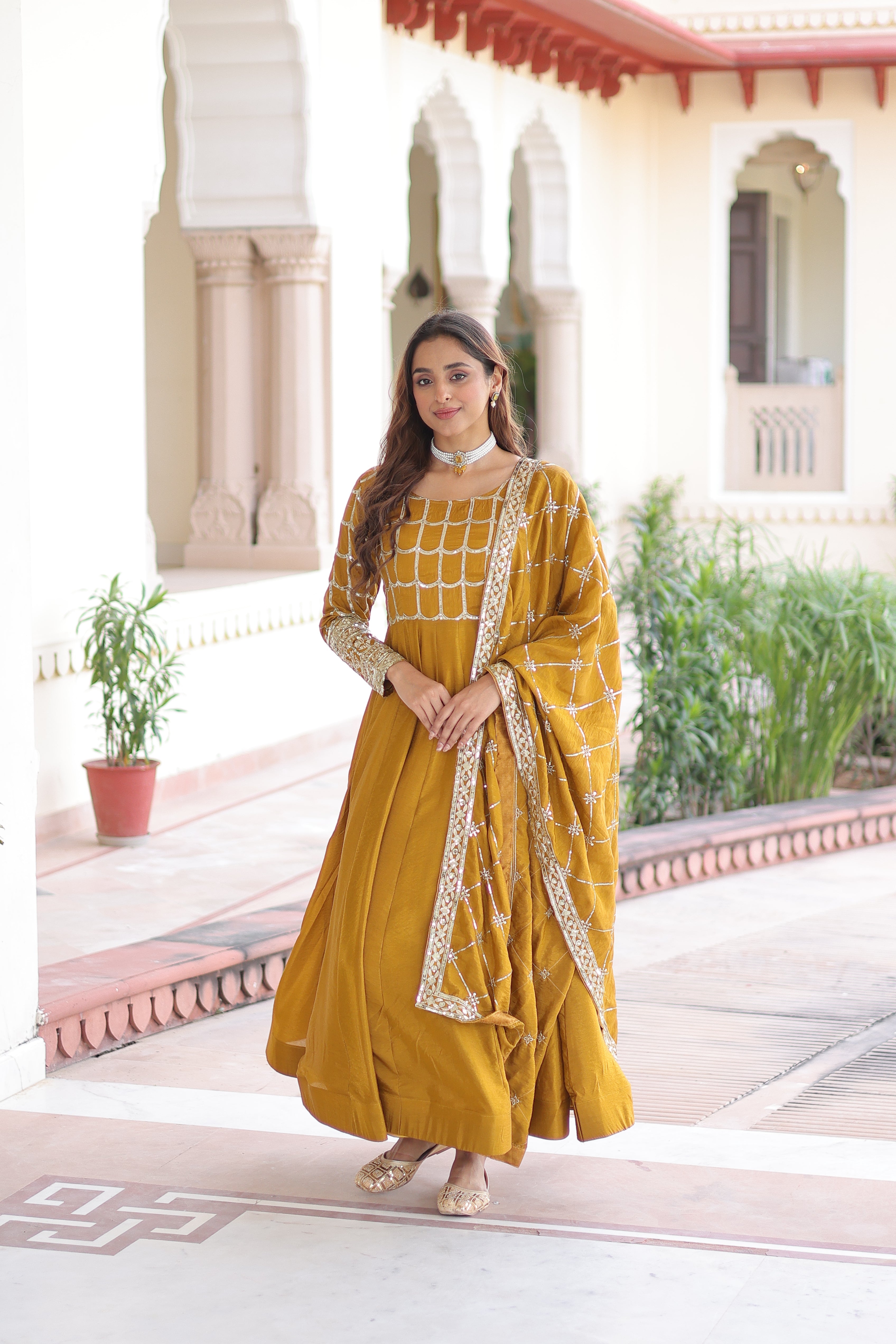 Navira mustard yellow Vichitra silk gown with rich sequins zari embroidery and dupatta