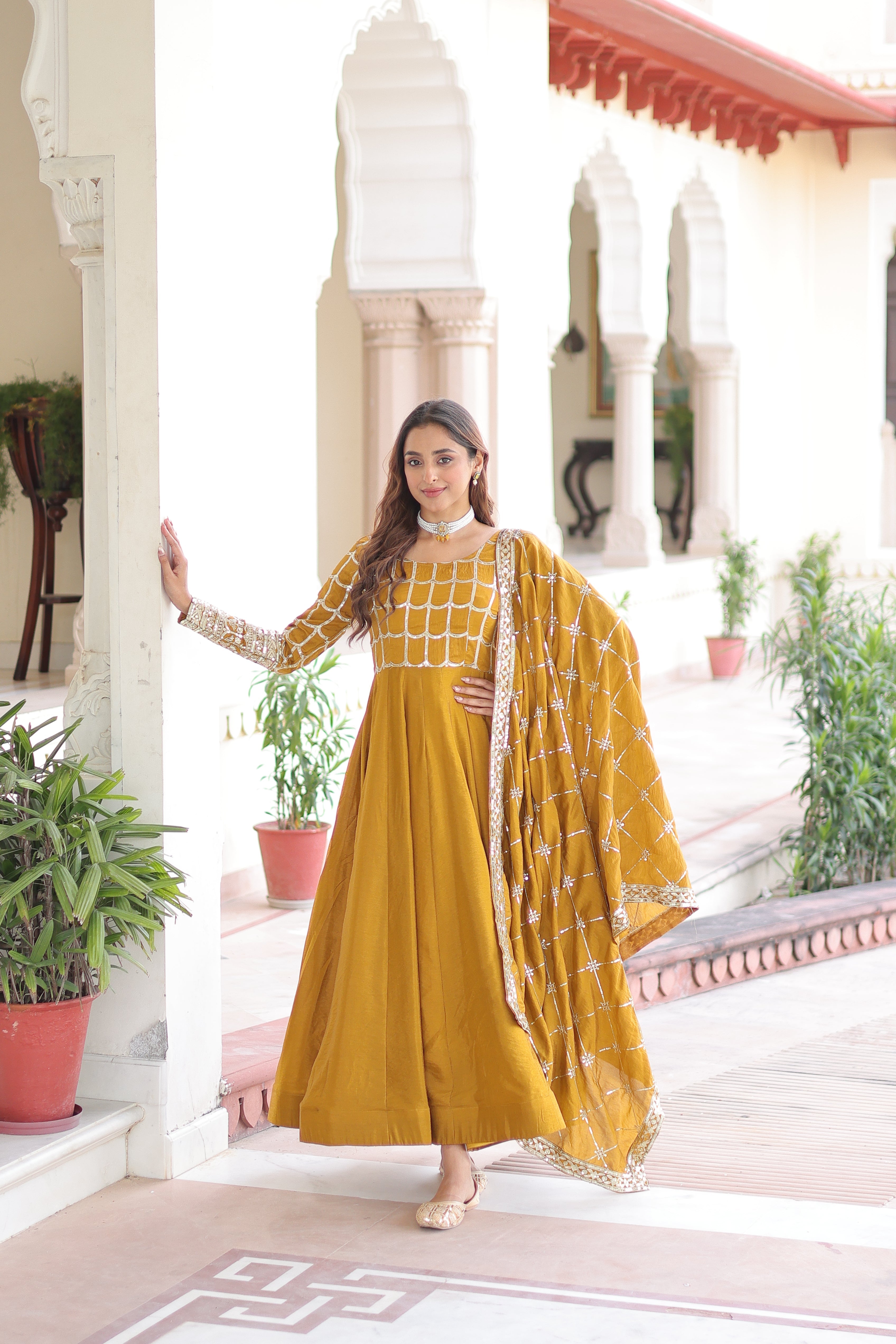 Navira mustard yellow Vichitra silk gown with rich sequins zari embroidery and dupatta
