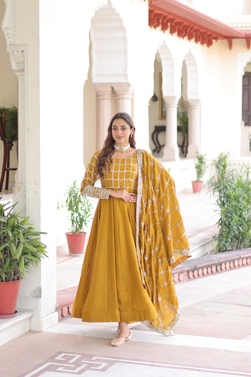 Navira mustard yellow Vichitra silk gown with rich sequins zari embroidery and dupatta
