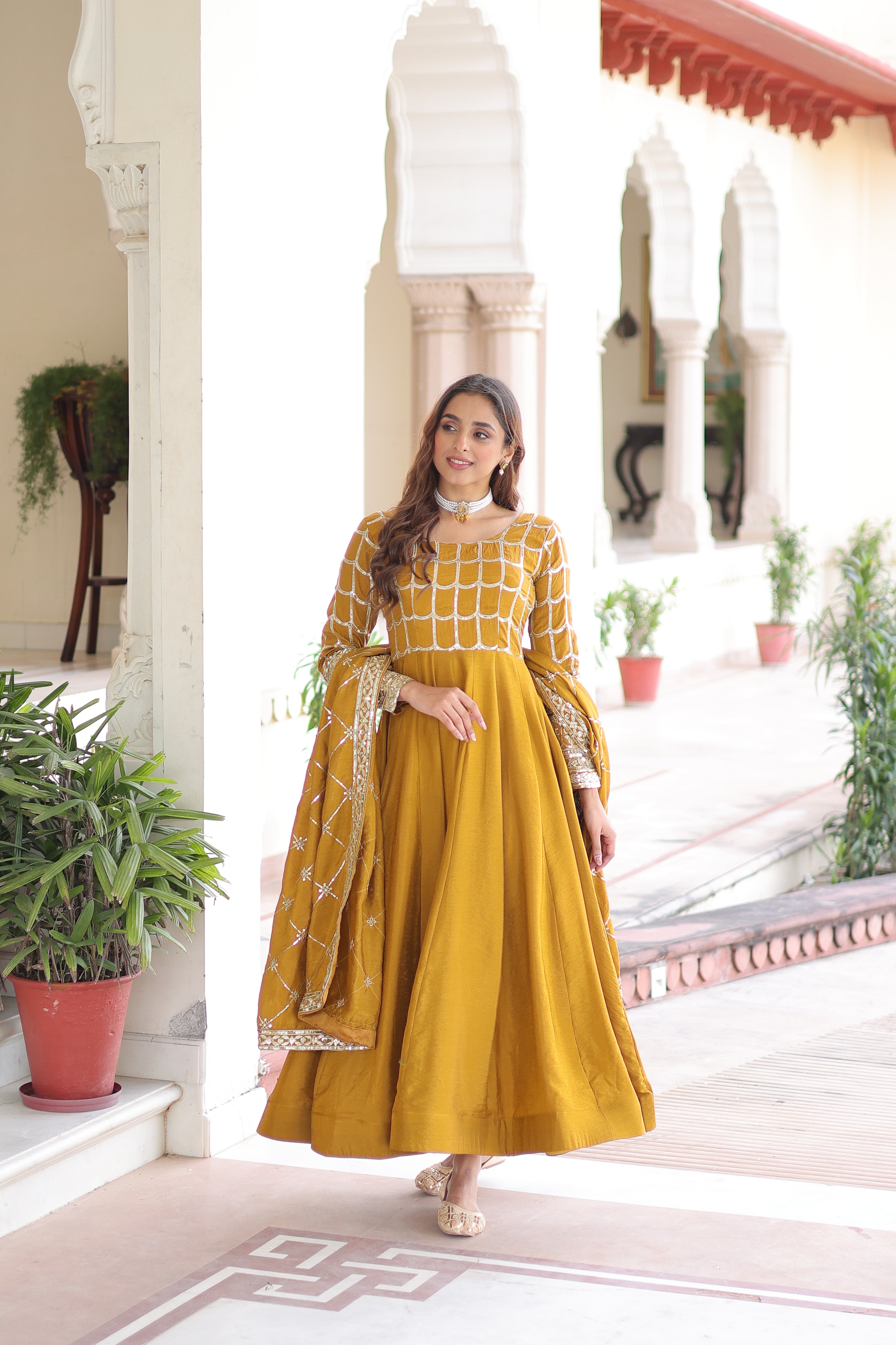 Navira mustard yellow Vichitra silk gown with rich sequins zari embroidery and dupatta