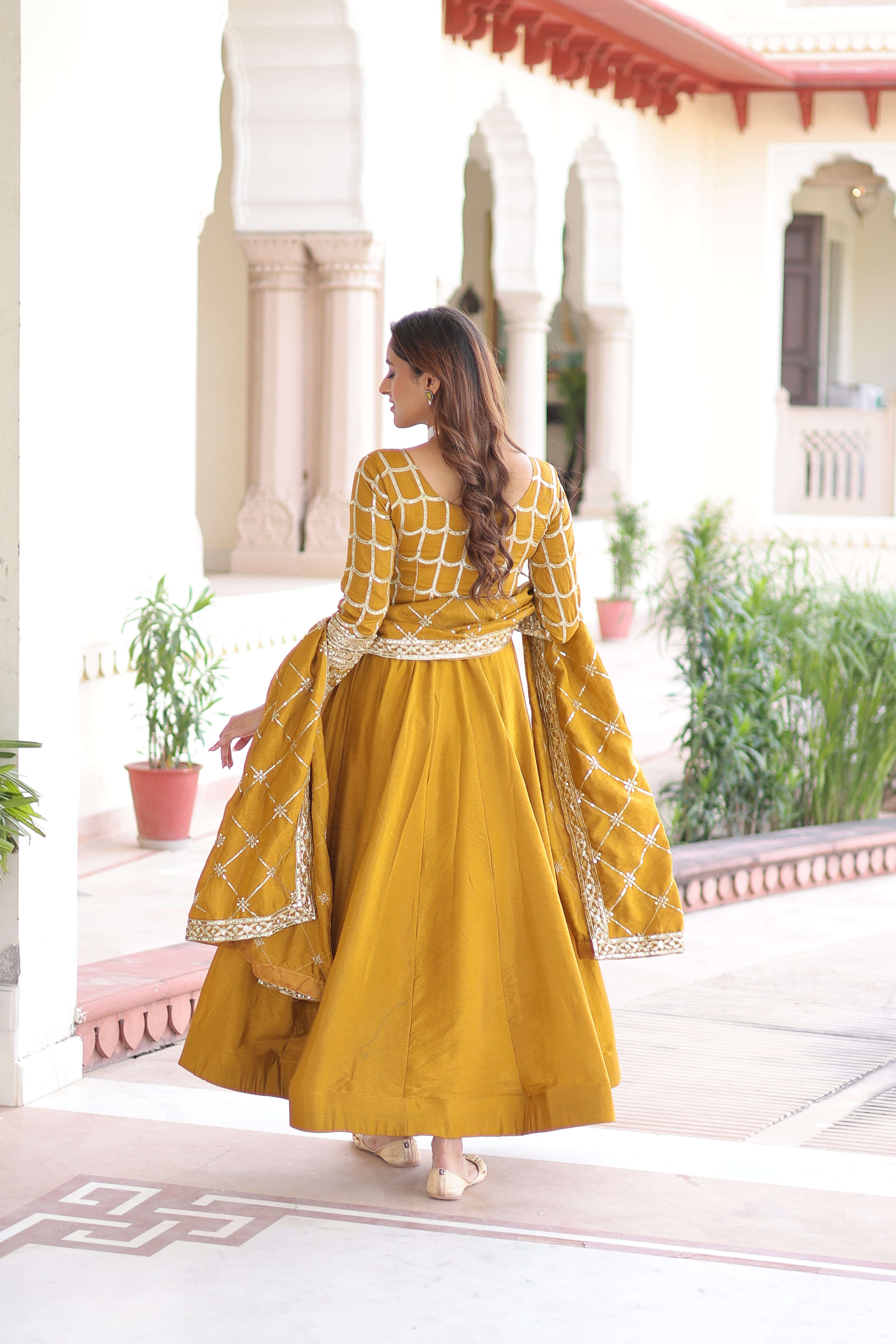 Navira mustard yellow Vichitra silk gown with rich sequins zari embroidery and dupatta