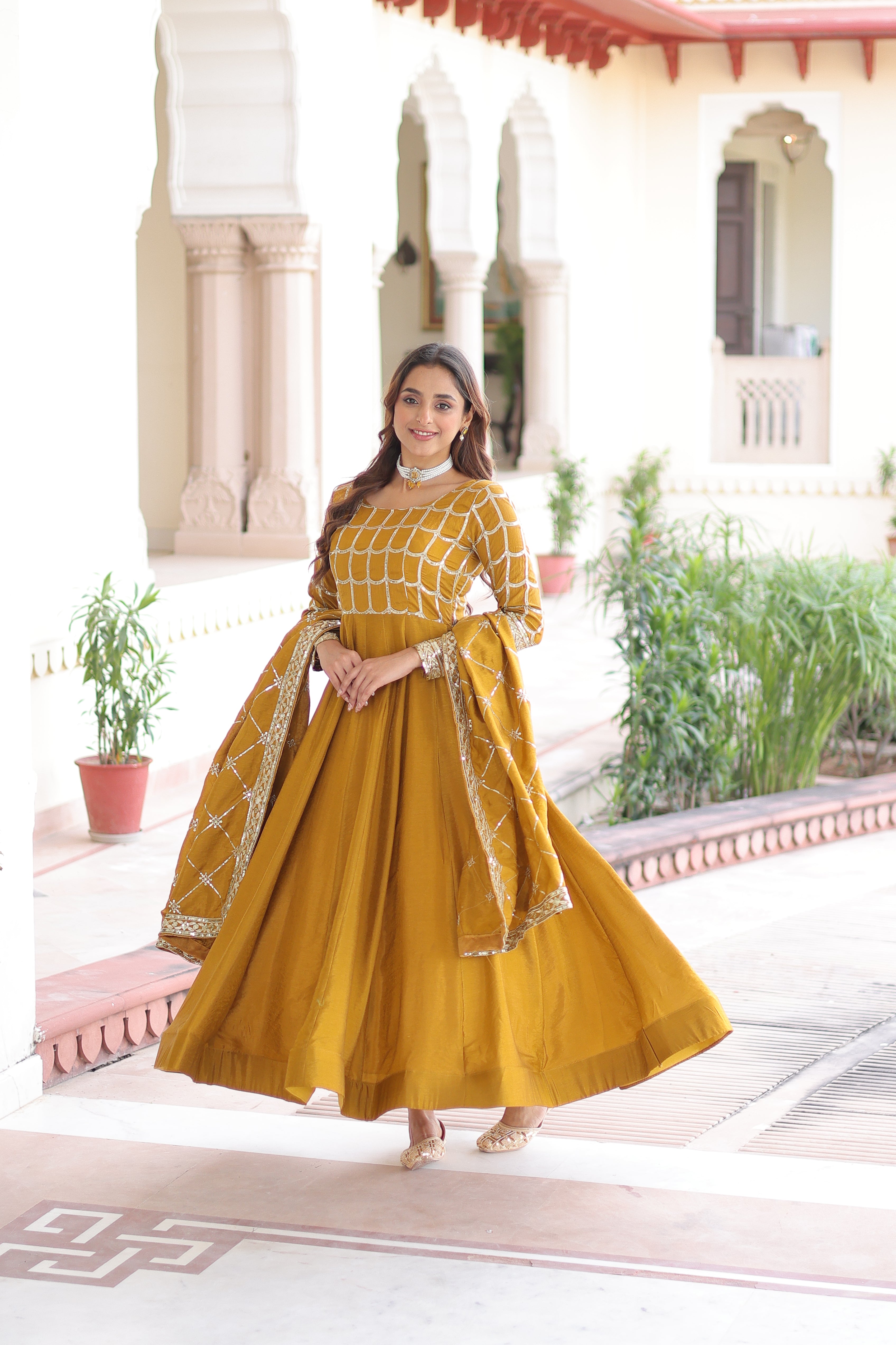 Navira mustard yellow Vichitra silk gown with rich sequins zari embroidery and dupatta