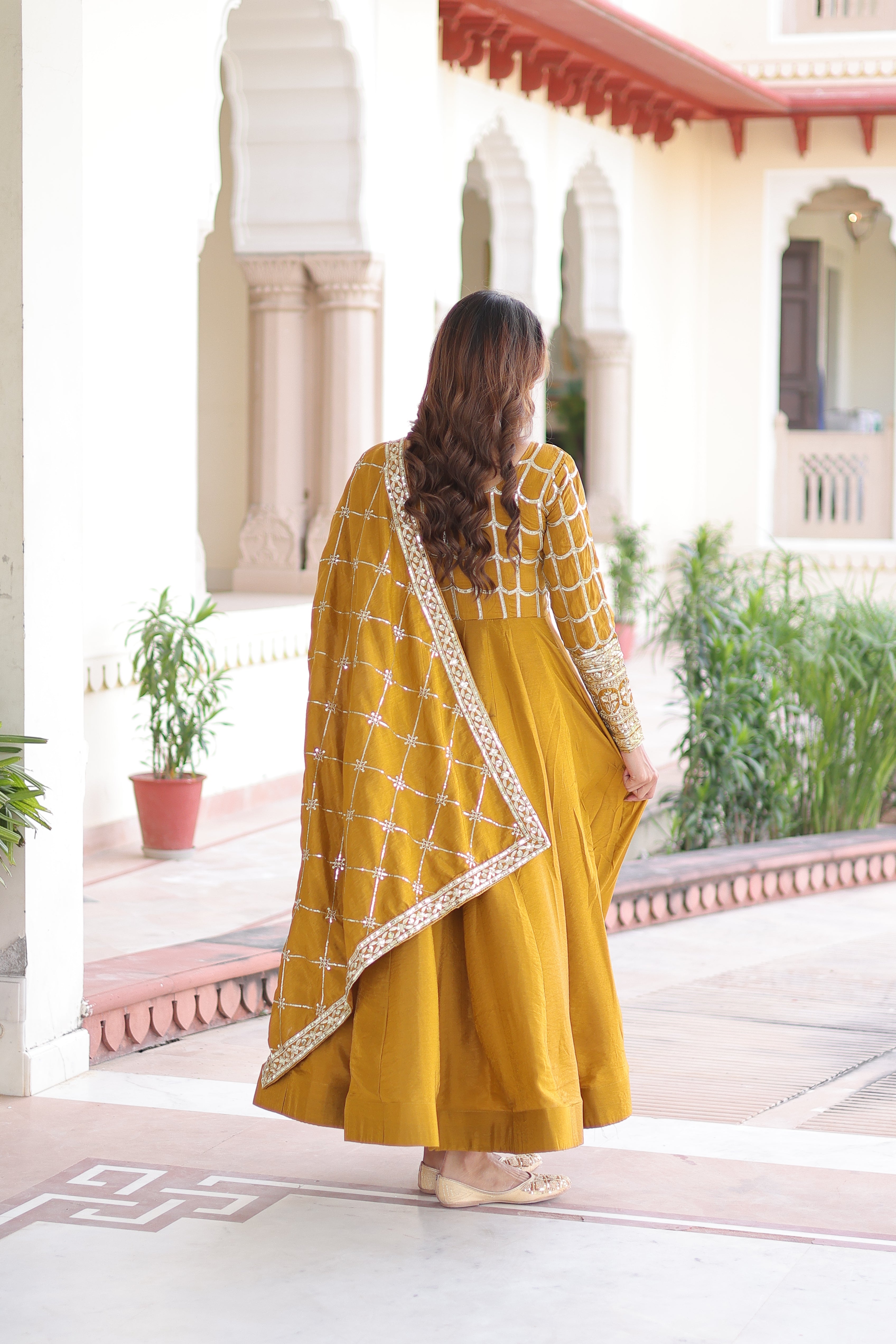 Navira mustard yellow Vichitra silk gown with rich sequins zari embroidery and dupatta