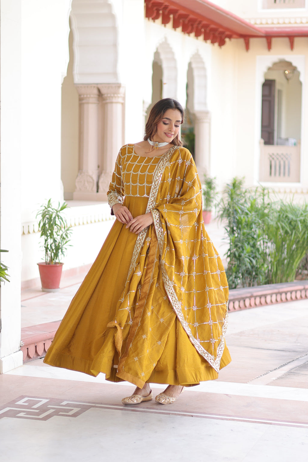 Navira mustard yellow Vichitra silk gown with rich sequins zari embroidery and dupatta