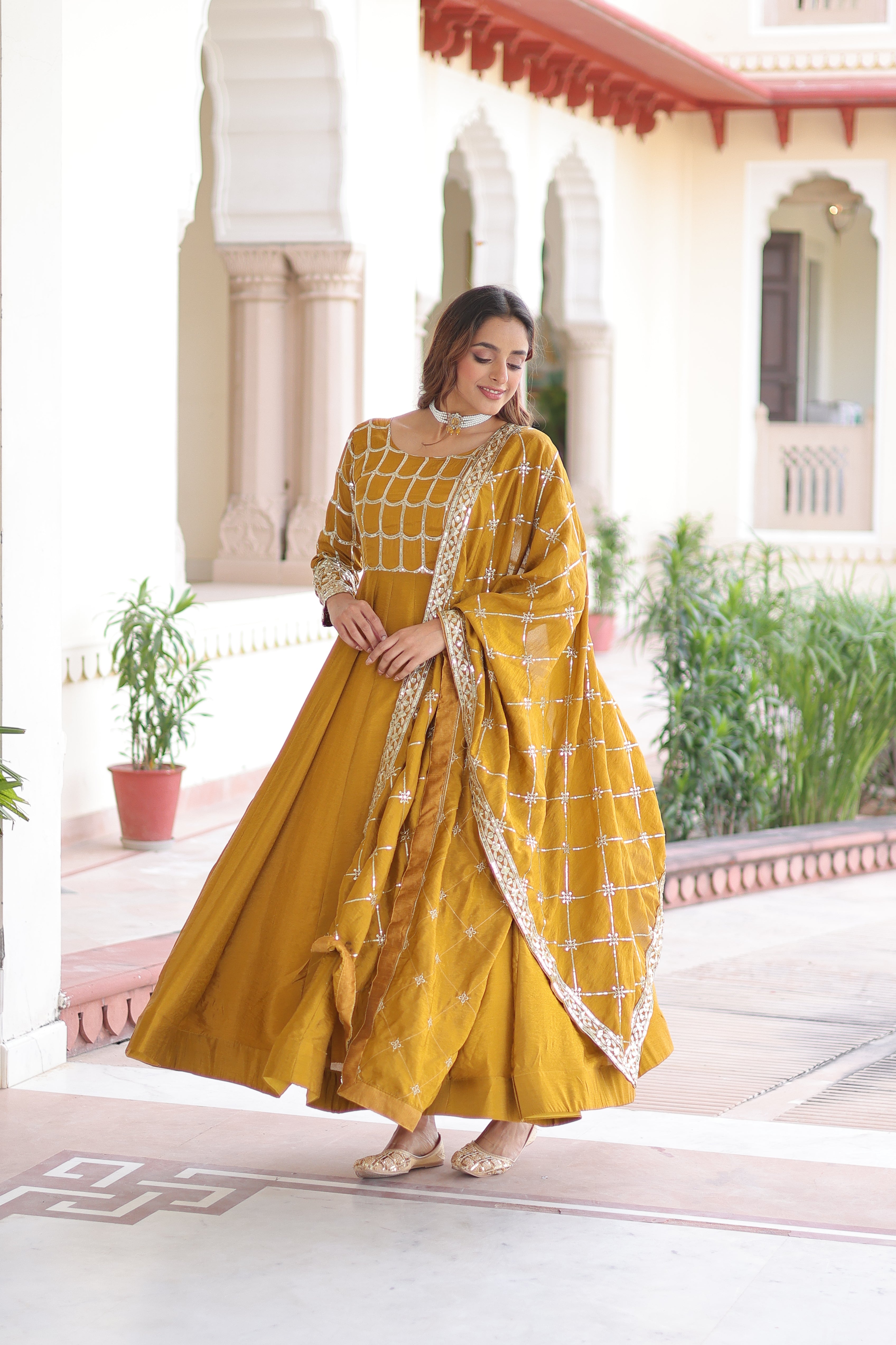 Navira mustard yellow Vichitra silk gown with rich sequins zari embroidery and dupatta