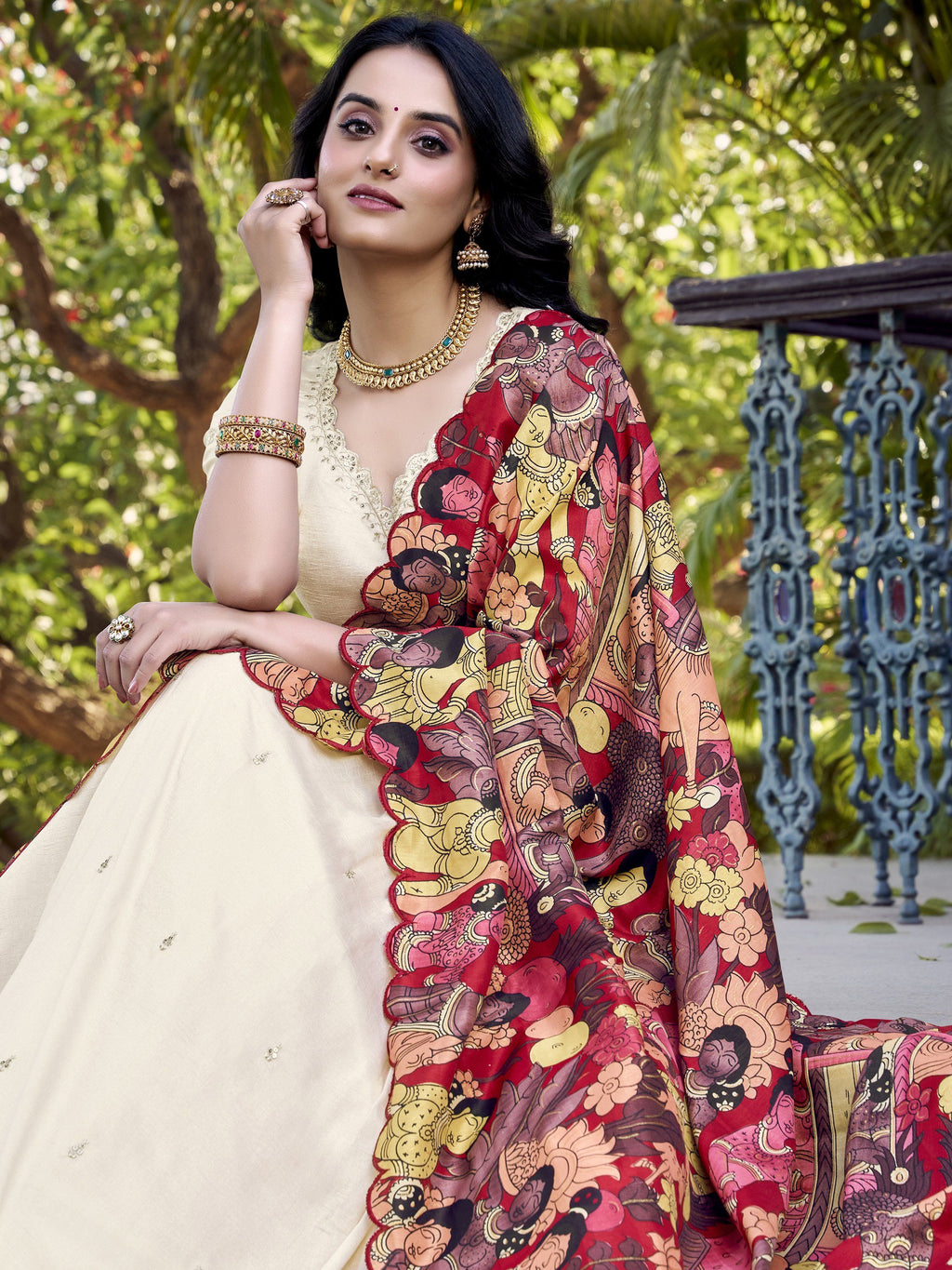 Off-white Vichitra silk lehenga choli with intricate sequin and thread embroidery, 4-meter flair, Kalamkari printed dupatta with scalloped border – a premium festive outfit for weddings and traditional celebrations