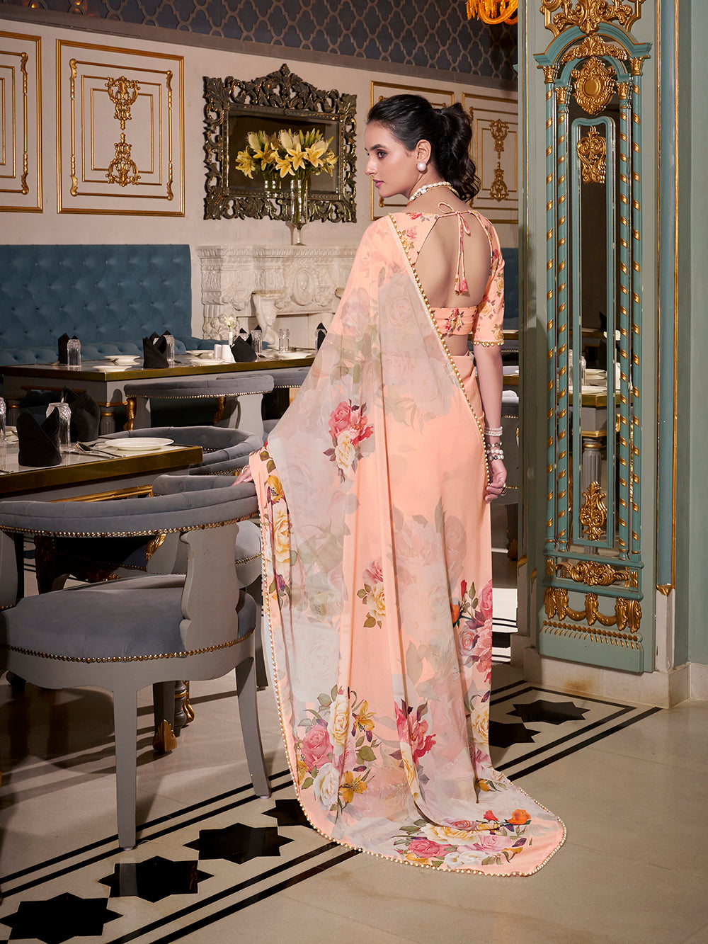 Peach georgette printed saree with pearl lace border