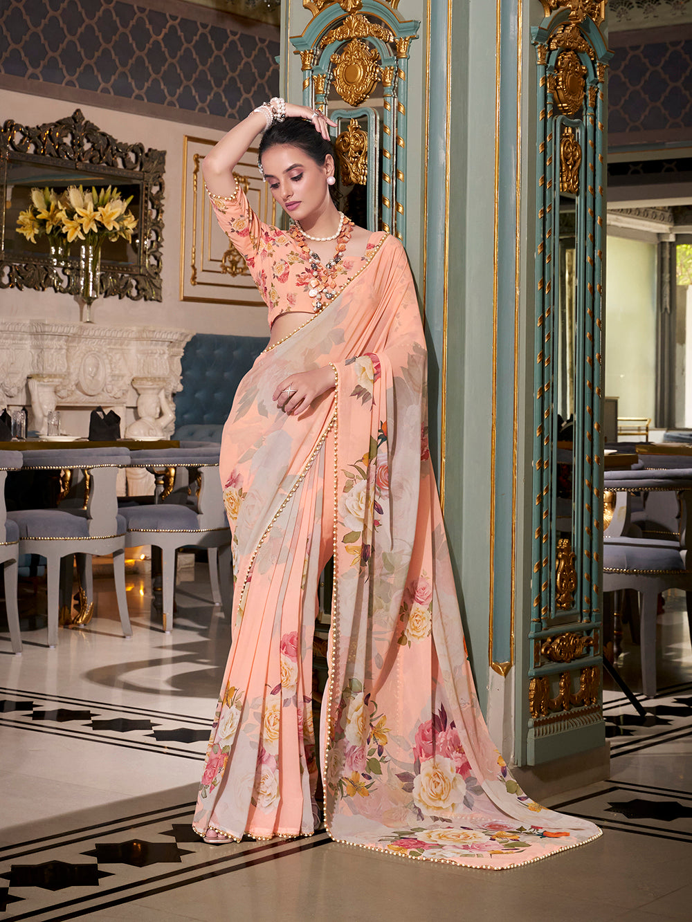 Peach georgette printed saree with pearl lace border