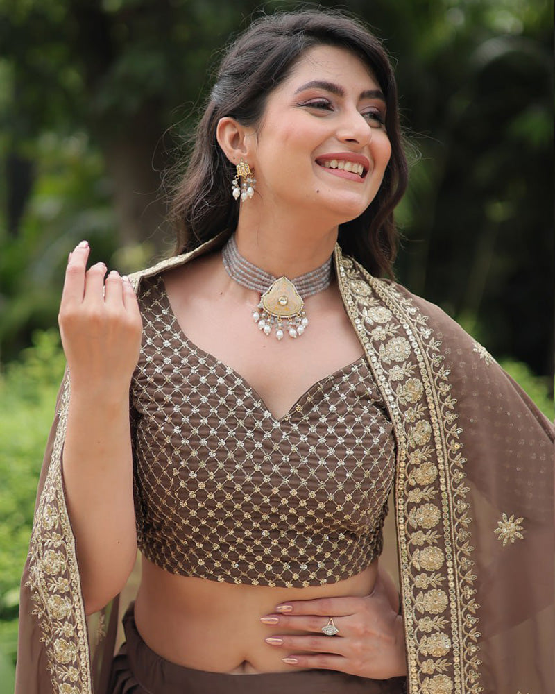 Rasika Brown Embroidered Designer Lehenga Choli with Heavy Sequins Work, Faux Blooming Fabric, and Faux Georgette Dupatta – Perfect for Weddings & Festive Wear.
