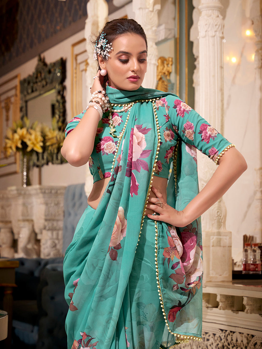 Turquoise georgette printed saree with pearl lace border