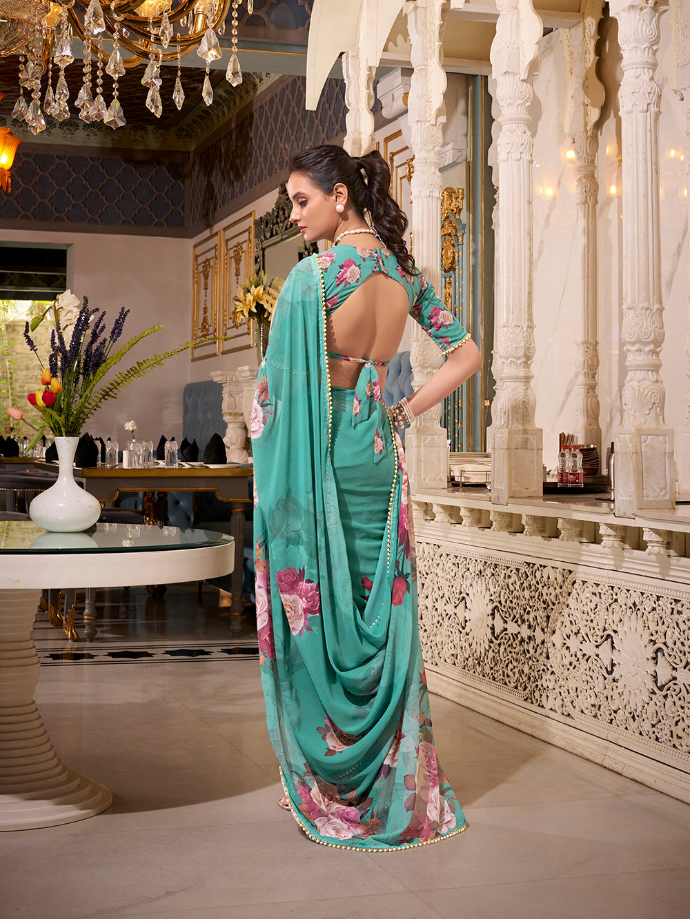 Turquoise georgette printed saree with pearl lace border