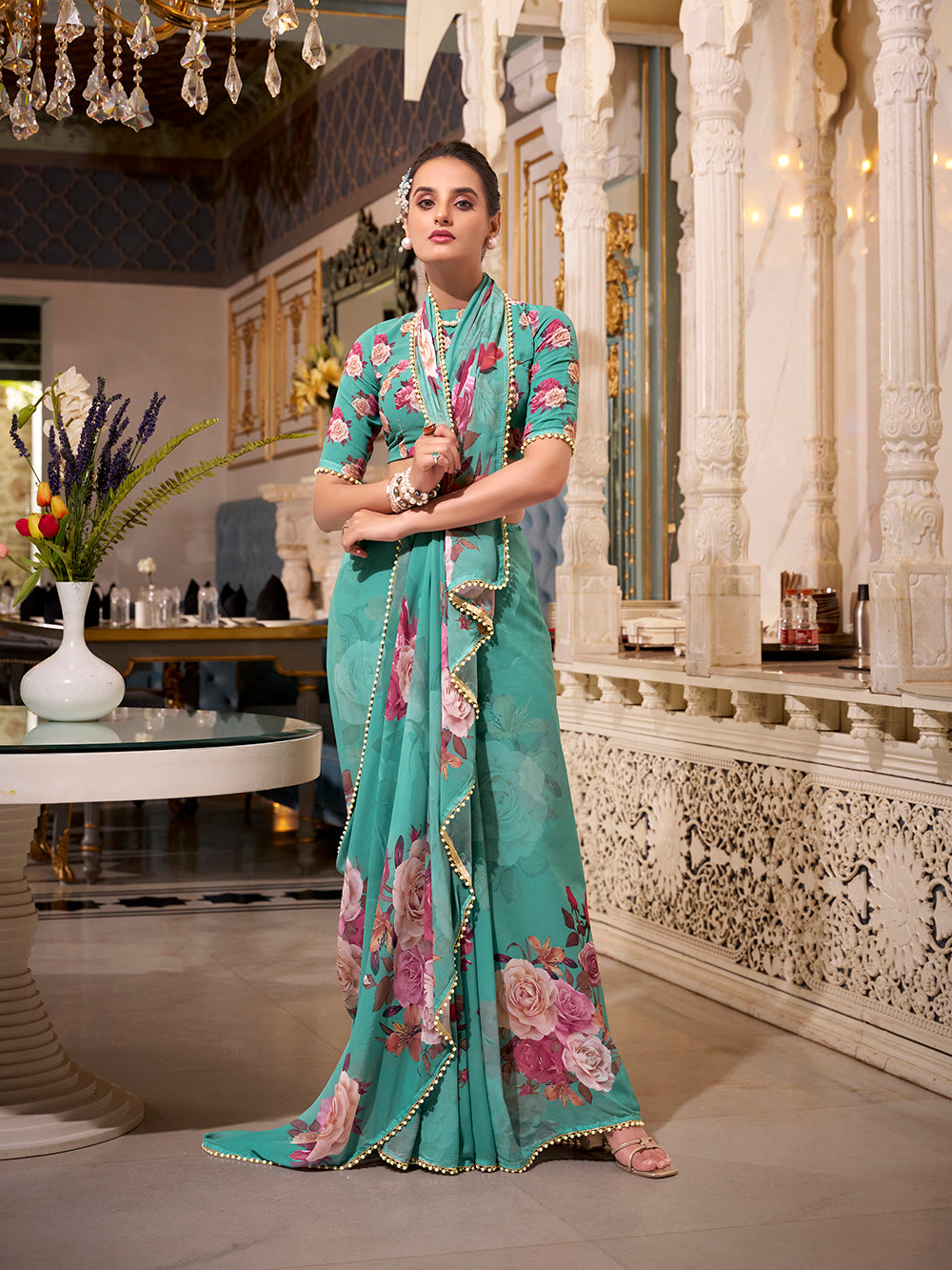Turquoise georgette printed saree with pearl lace border