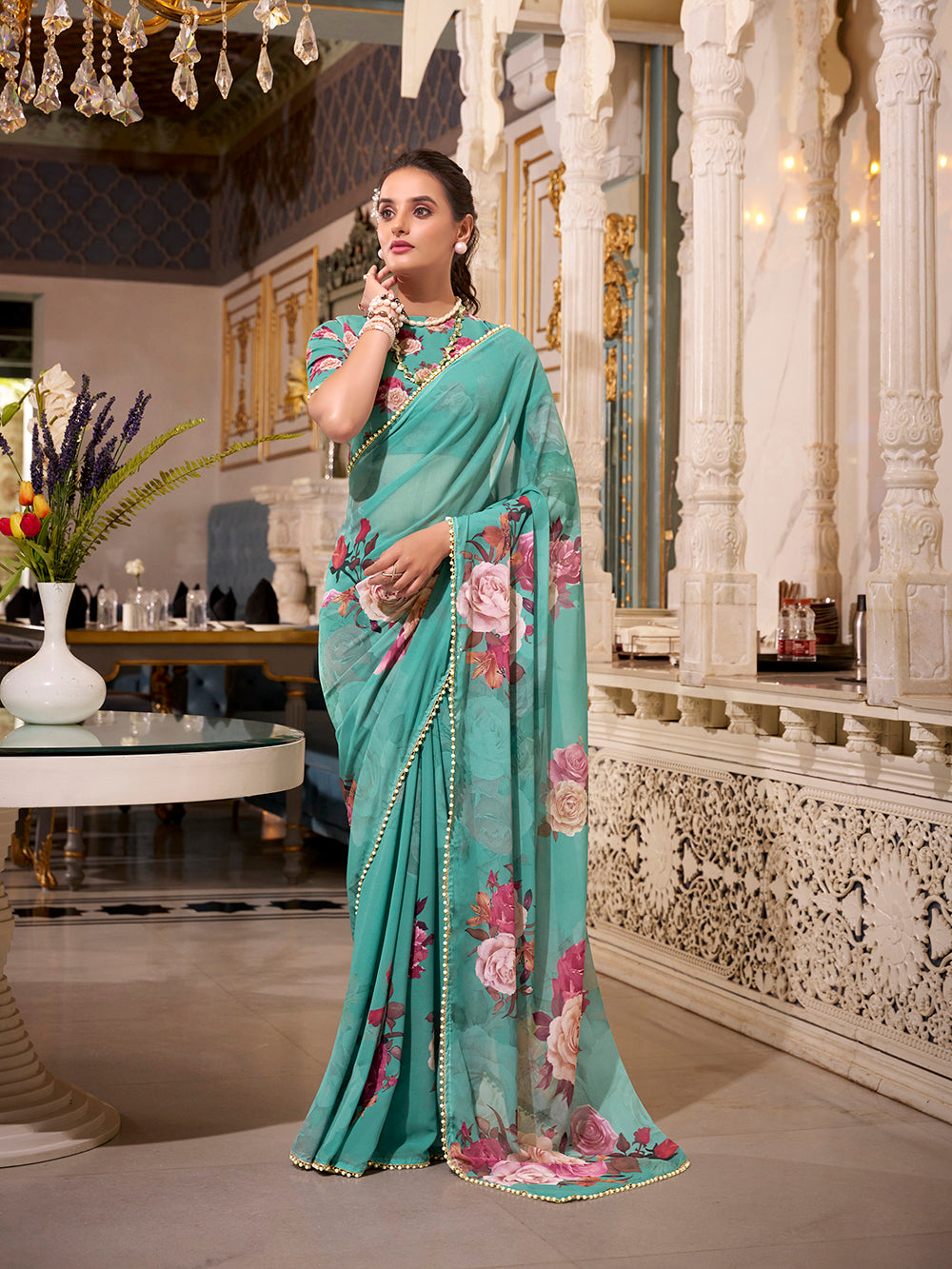 Turquoise georgette printed saree with pearl lace border