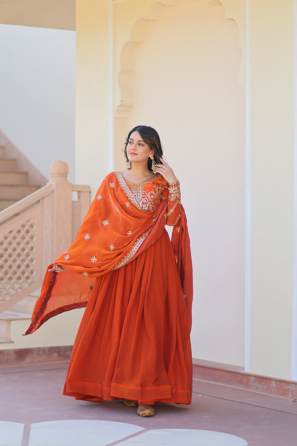 Varnita Orange Gown in Fendy Silk with zari & sequin work, full sleeves, V-neck & dupatta – regal festive wear, fully stitched.