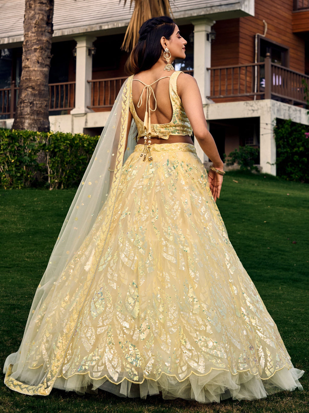Yellow net sequins embroidered party wear lehenga choli