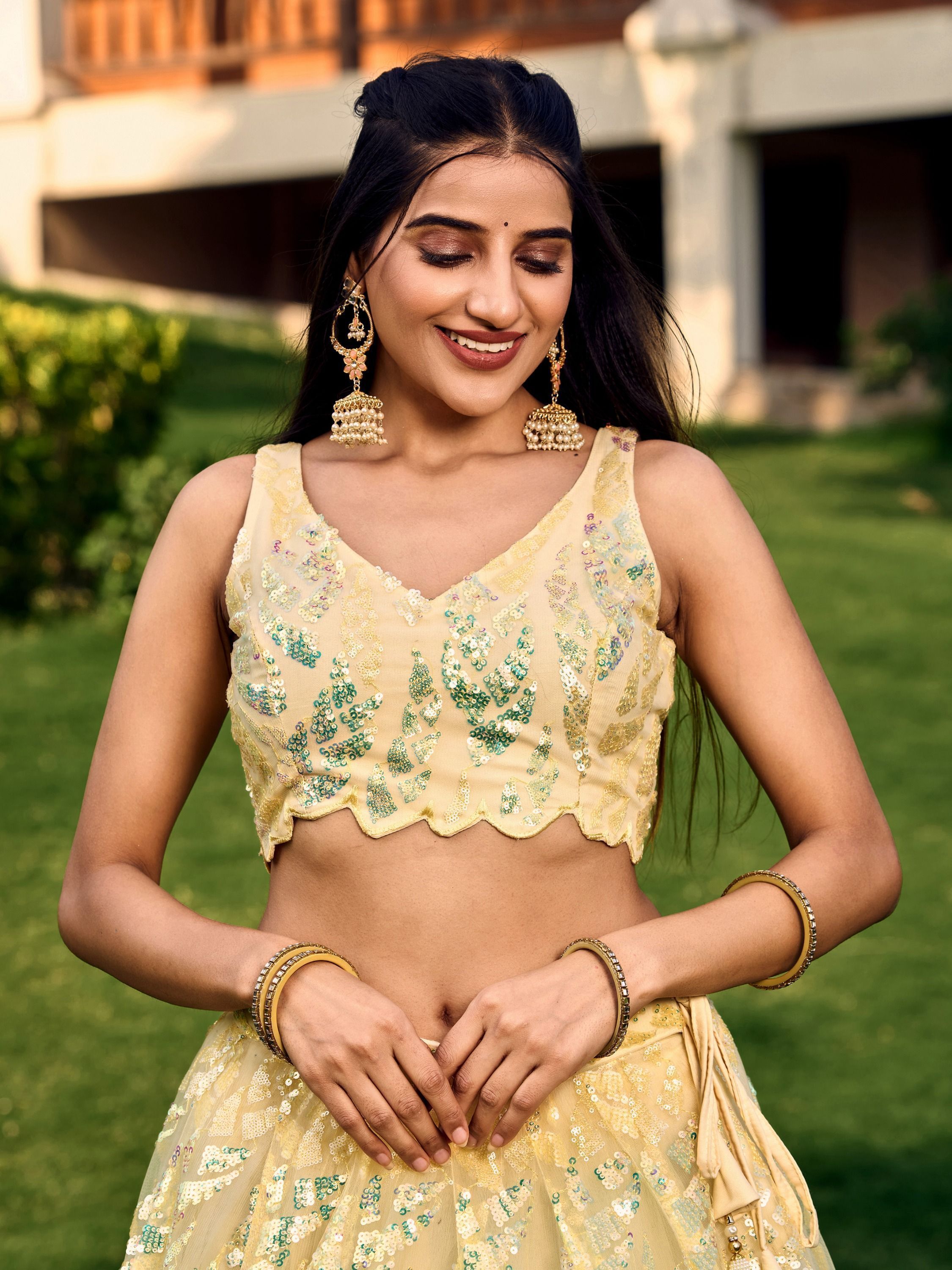 Yellow net sequins embroidered party wear lehenga choli