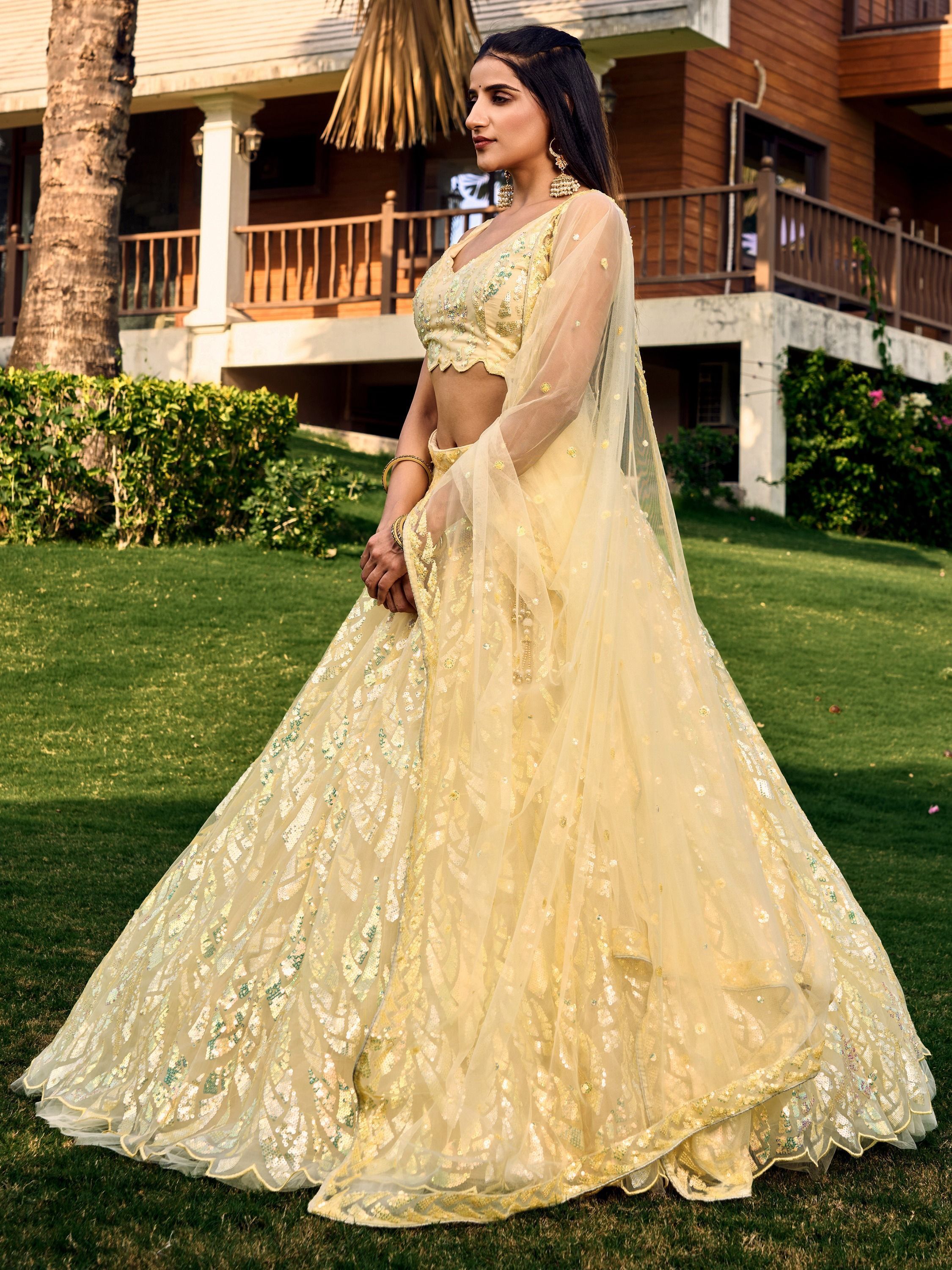 Yellow net sequins embroidered party wear lehenga choli
