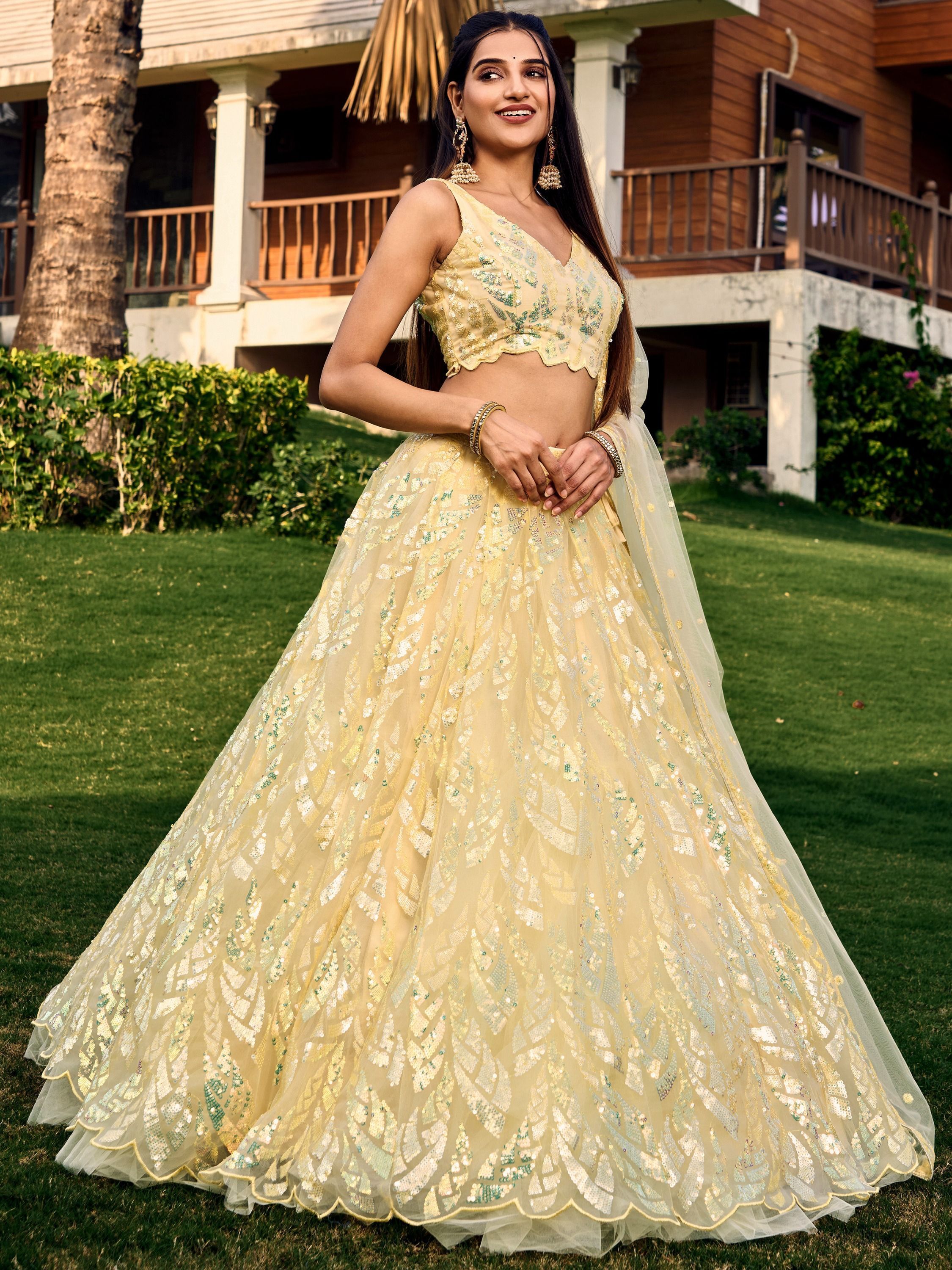 Yellow net sequins embroidered party wear lehenga choli