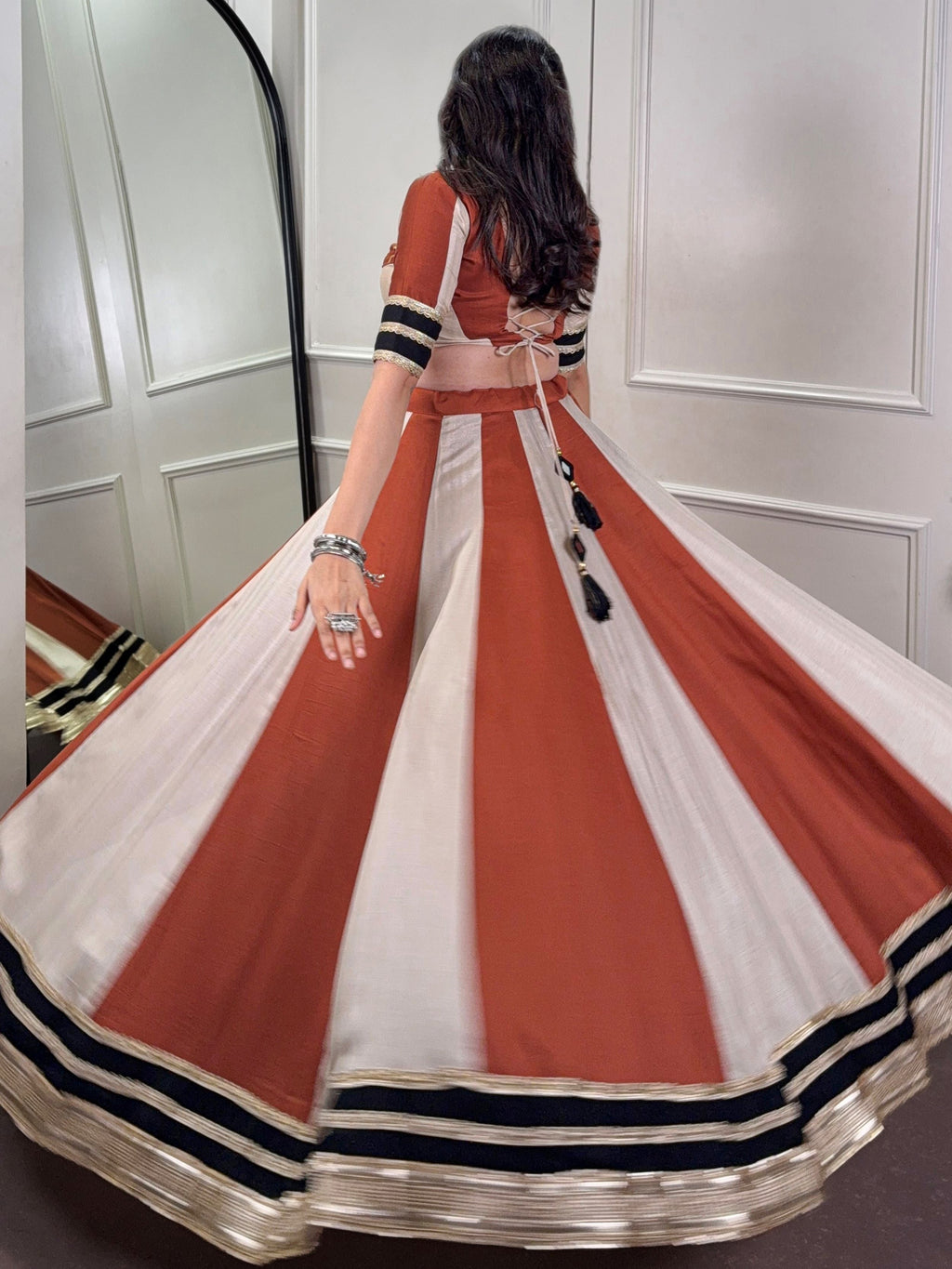 Rust orange rangoli silk lehenga choli with embroidered sequins work
