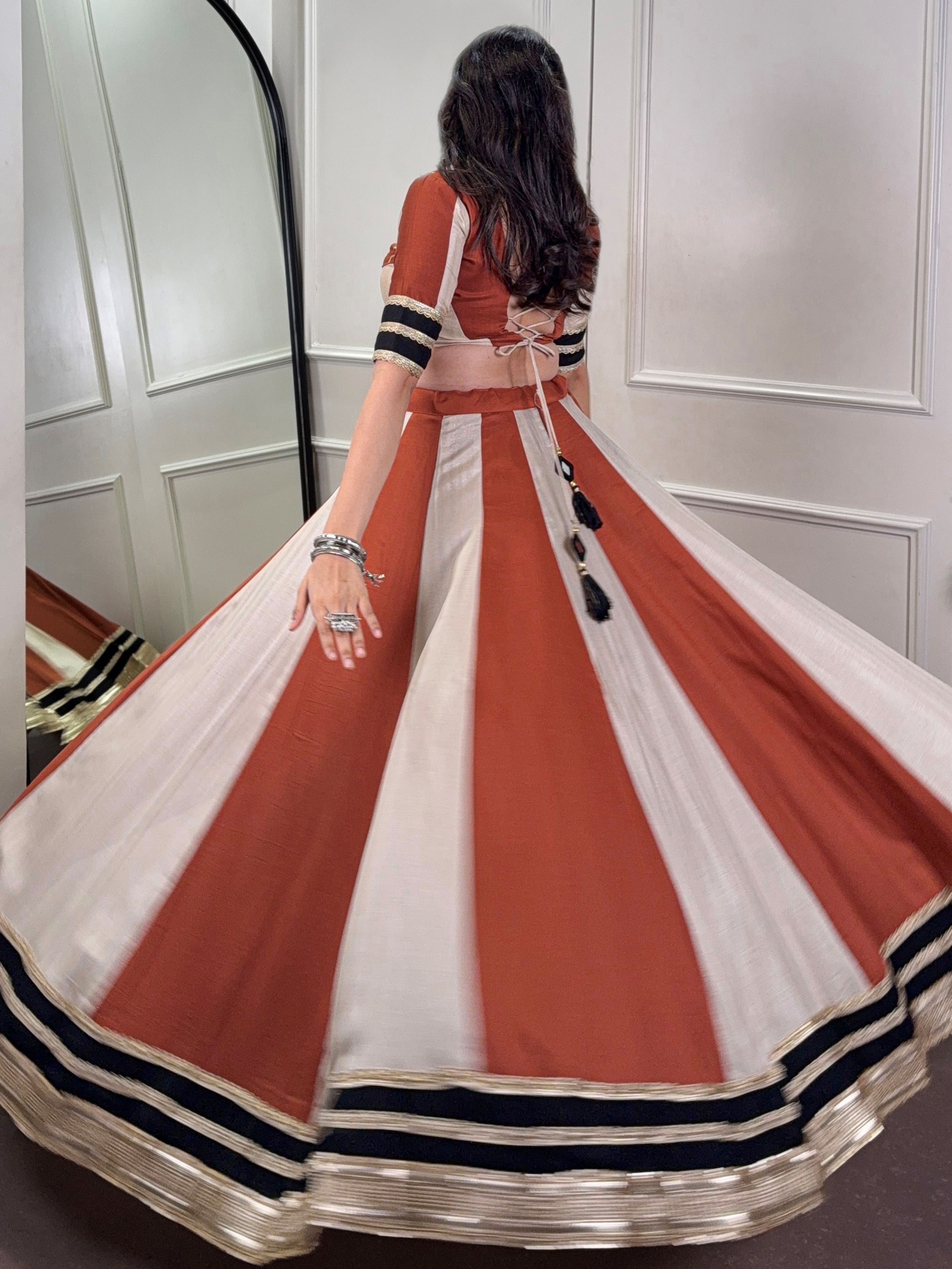 Rust orange rangoli silk lehenga choli with embroidered sequins work