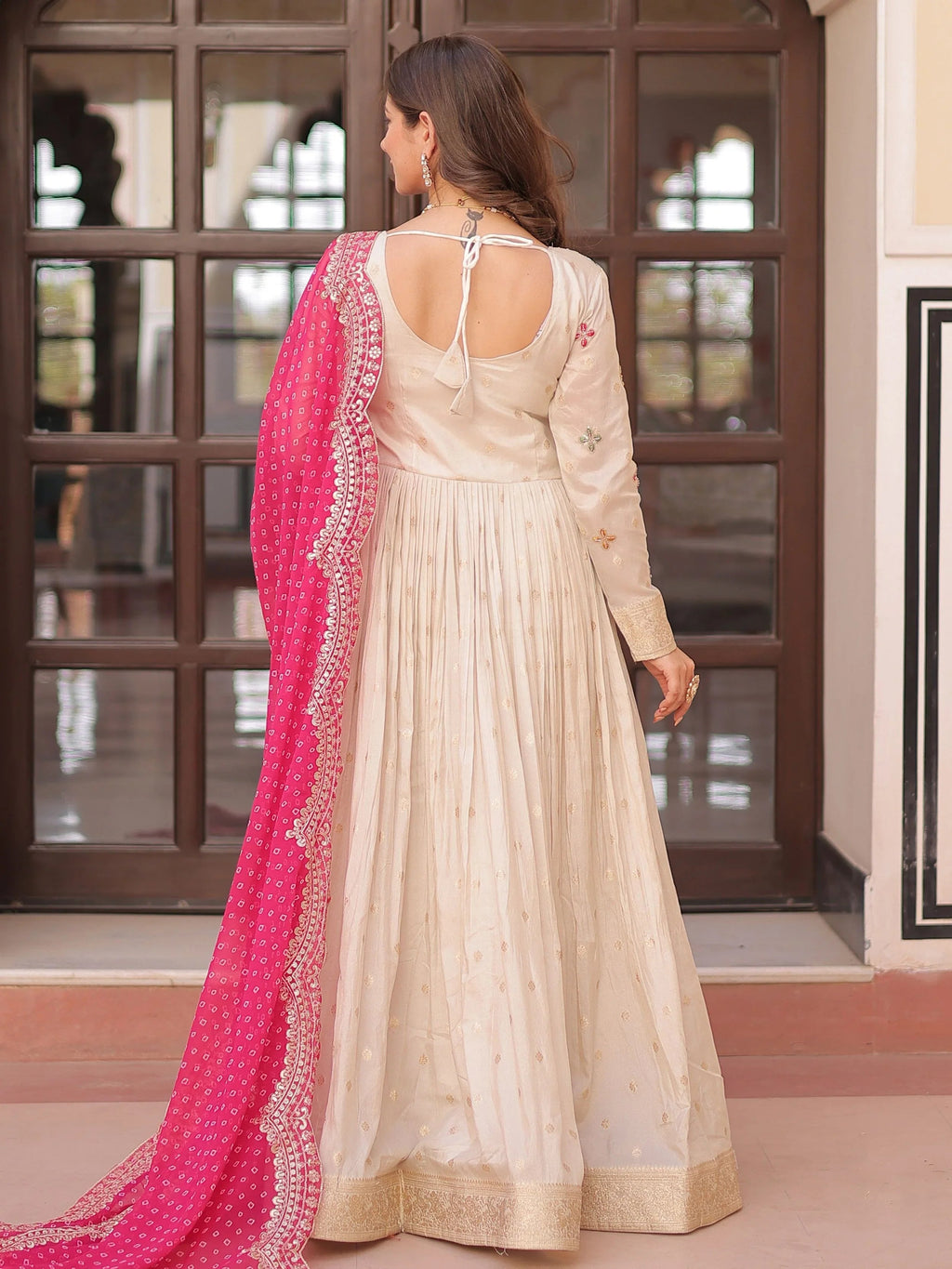 Cream silk gown with pearl beads embroidery and pink bandhani dupatta