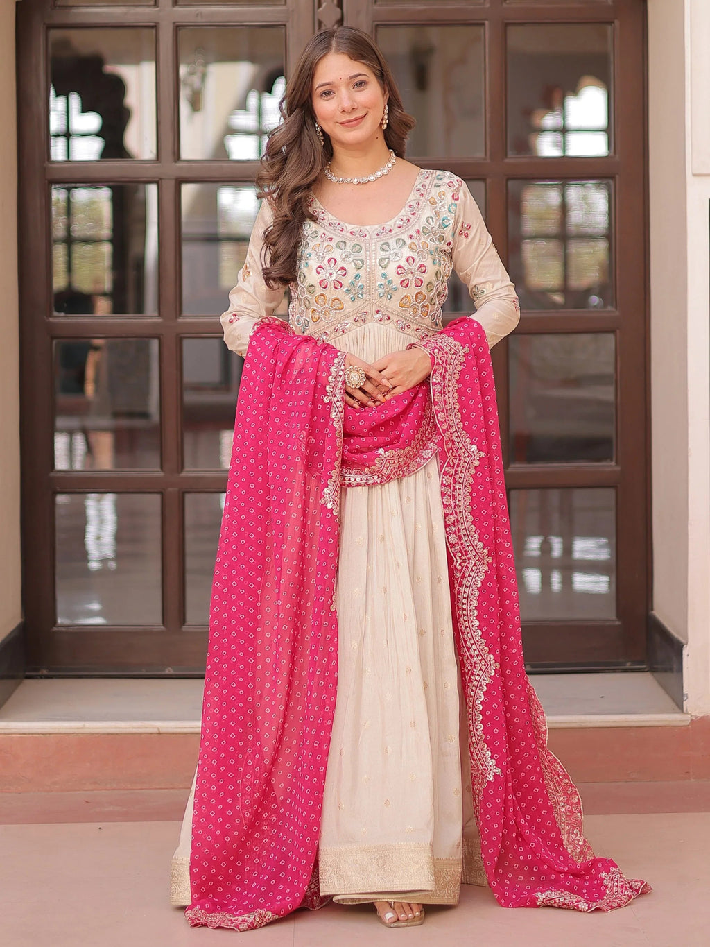 Cream silk gown with pearl beads embroidery and pink bandhani dupatta