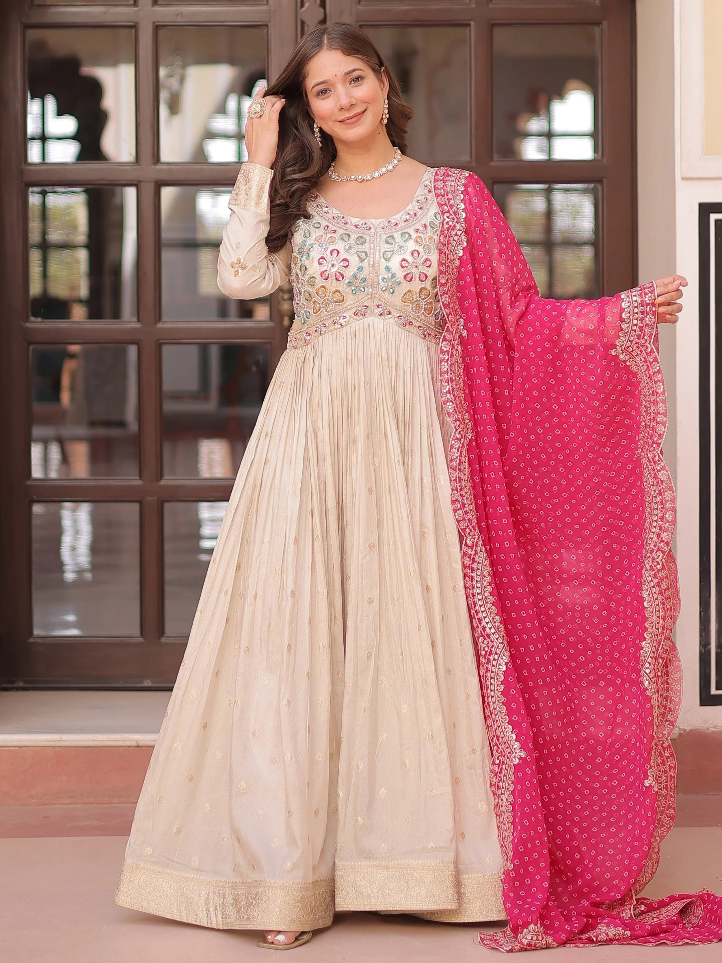 Cream silk gown with pearl beads embroidery and pink bandhani dupatta