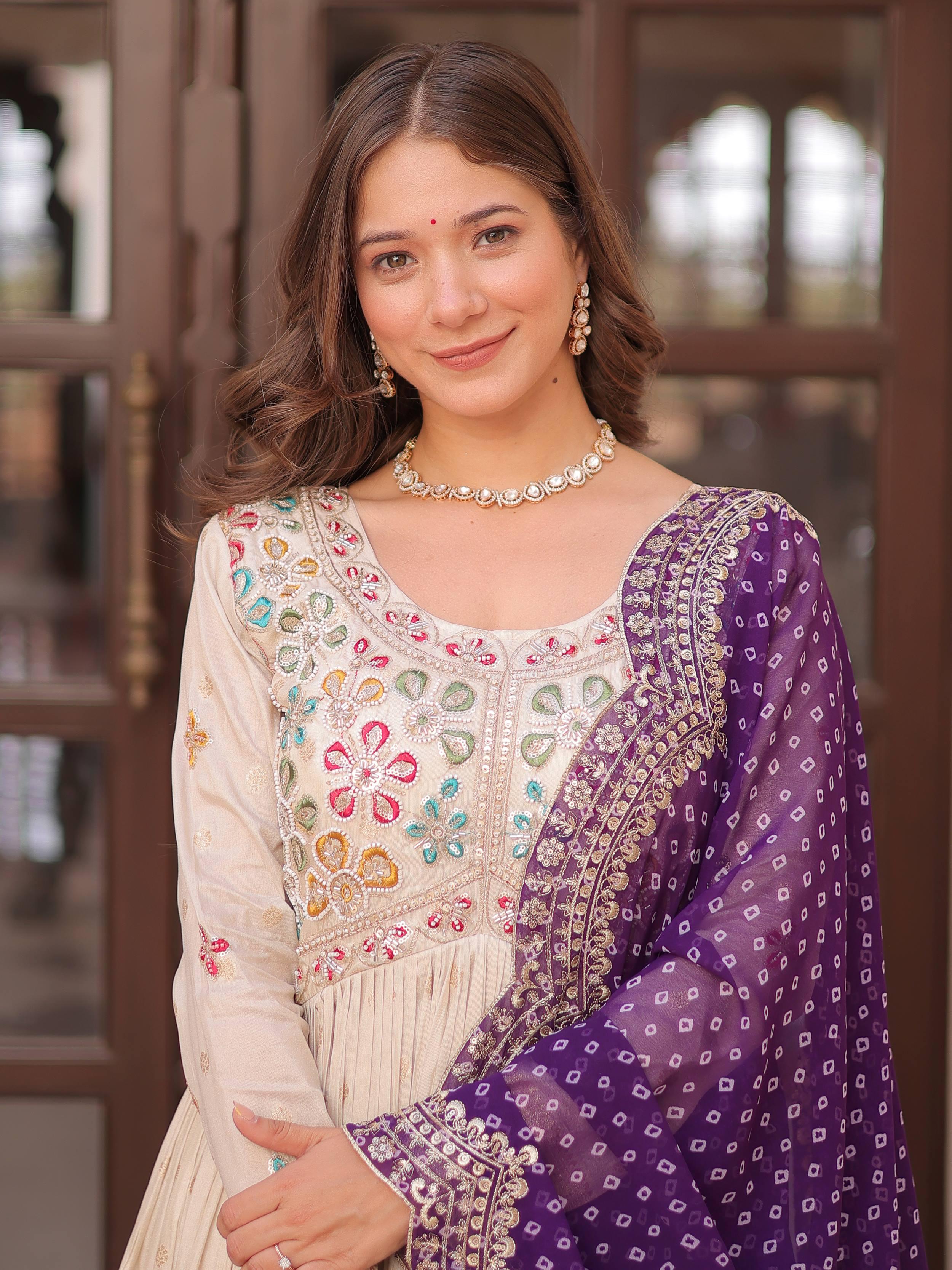 Cream silk gown with pearl beads embroidery and purple bandhani dupatta