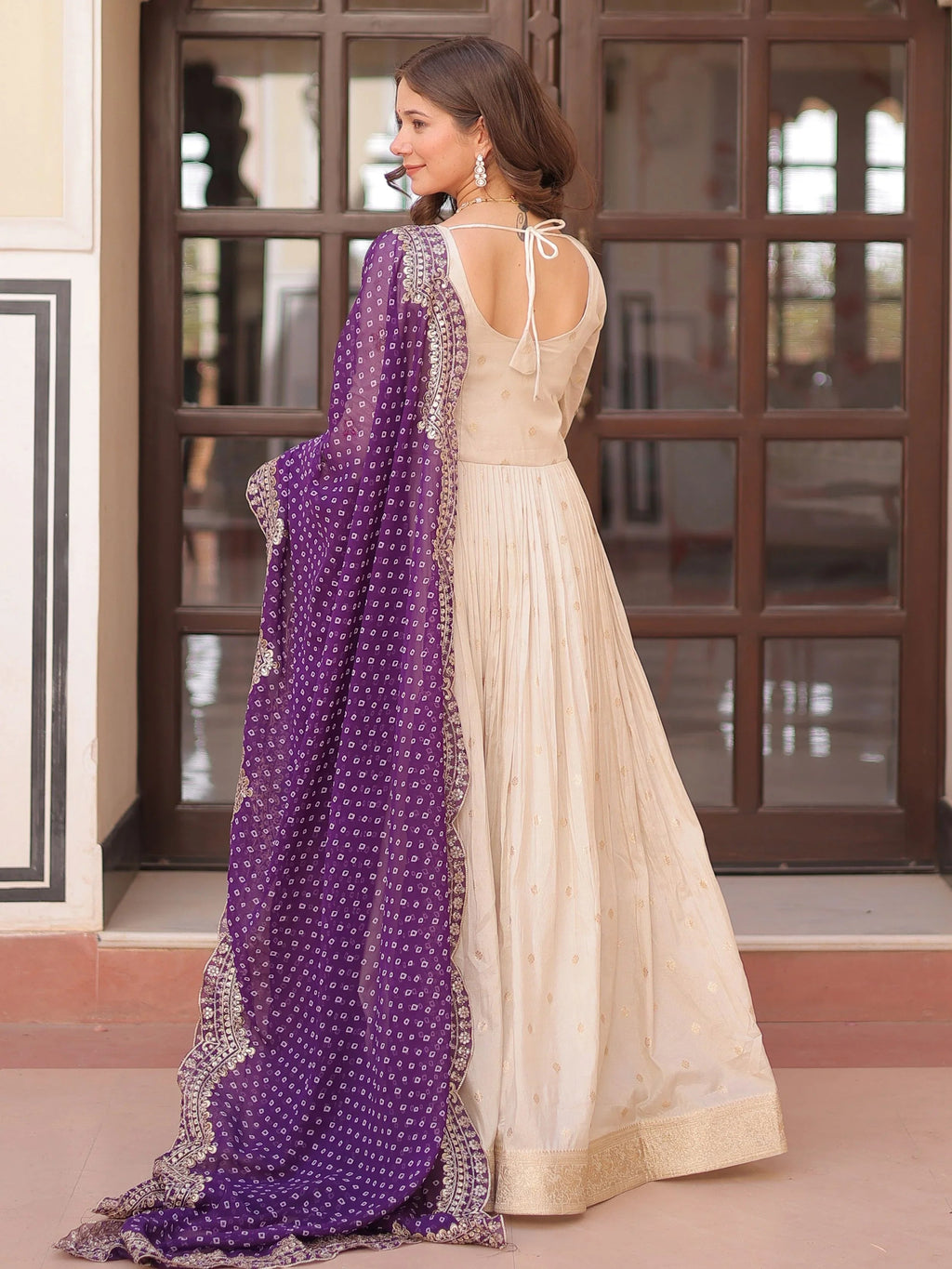 Cream silk gown with pearl beads embroidery and purple bandhani dupatta
