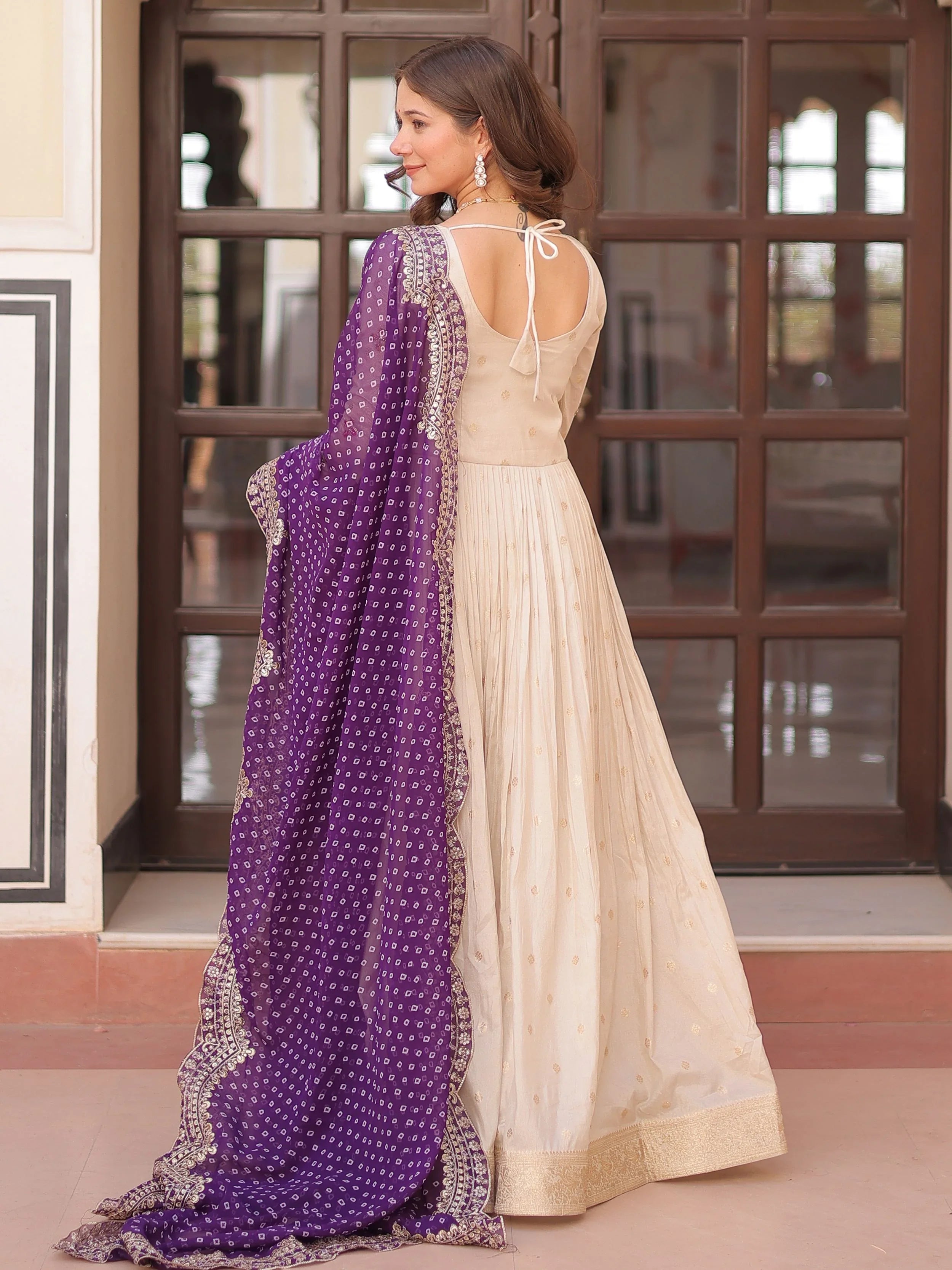 Cream silk gown with pearl beads embroidery and purple bandhani dupatta