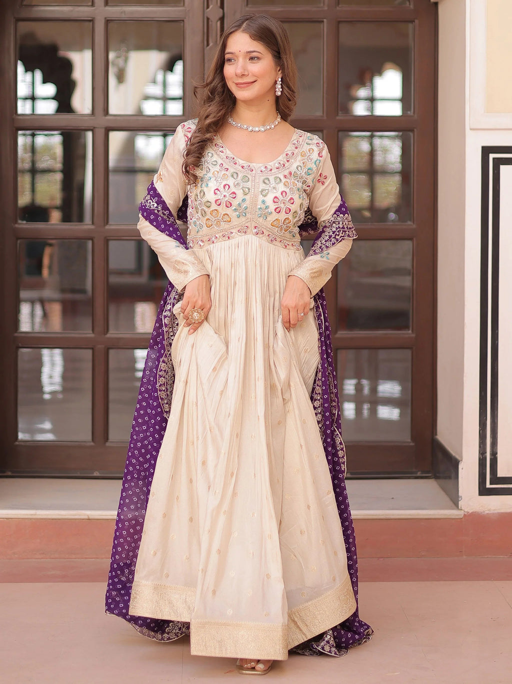 Cream silk gown with pearl beads embroidery and purple bandhani dupatta