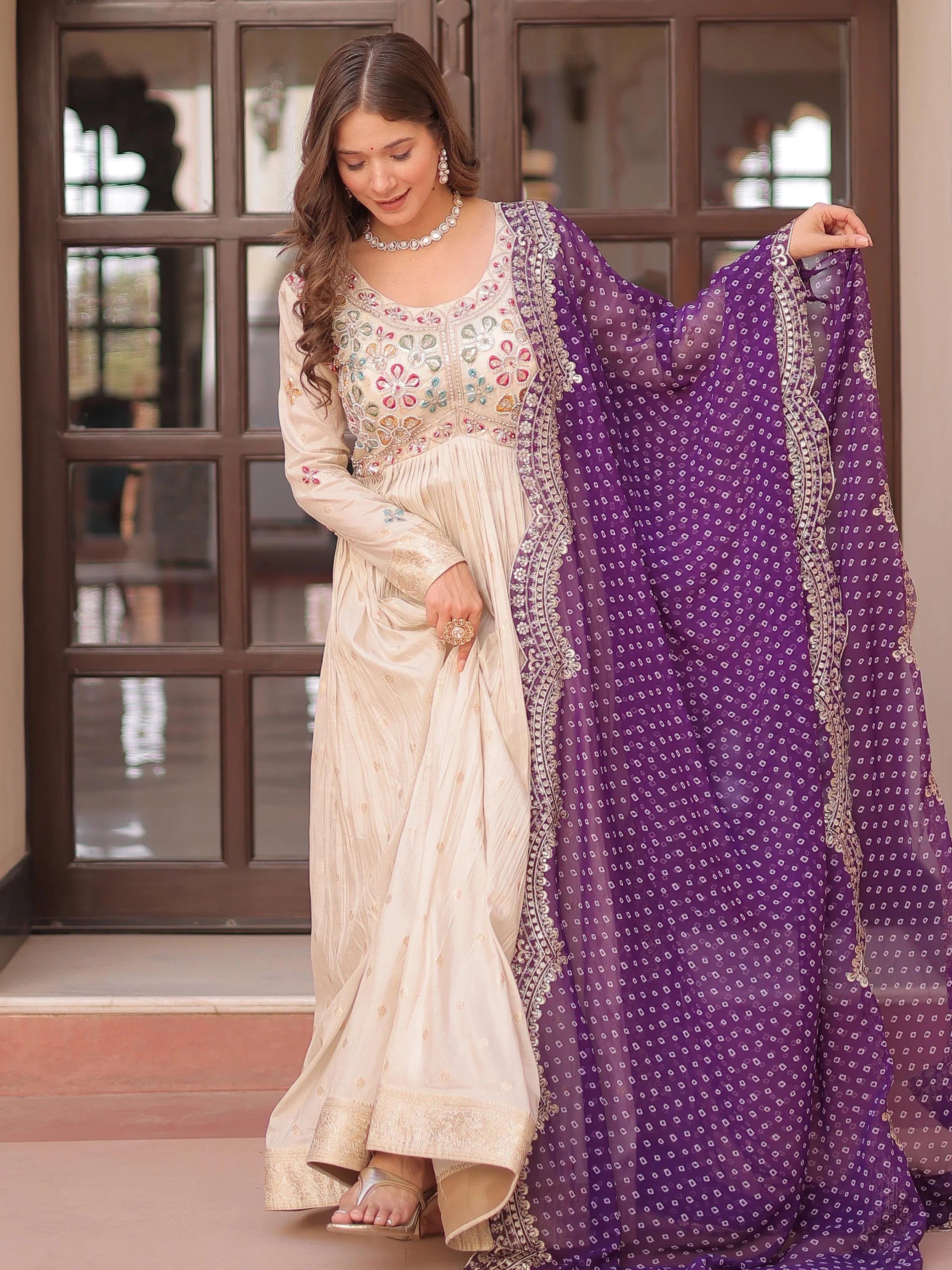 Cream silk gown with pearl beads embroidery and purple bandhani dupatta