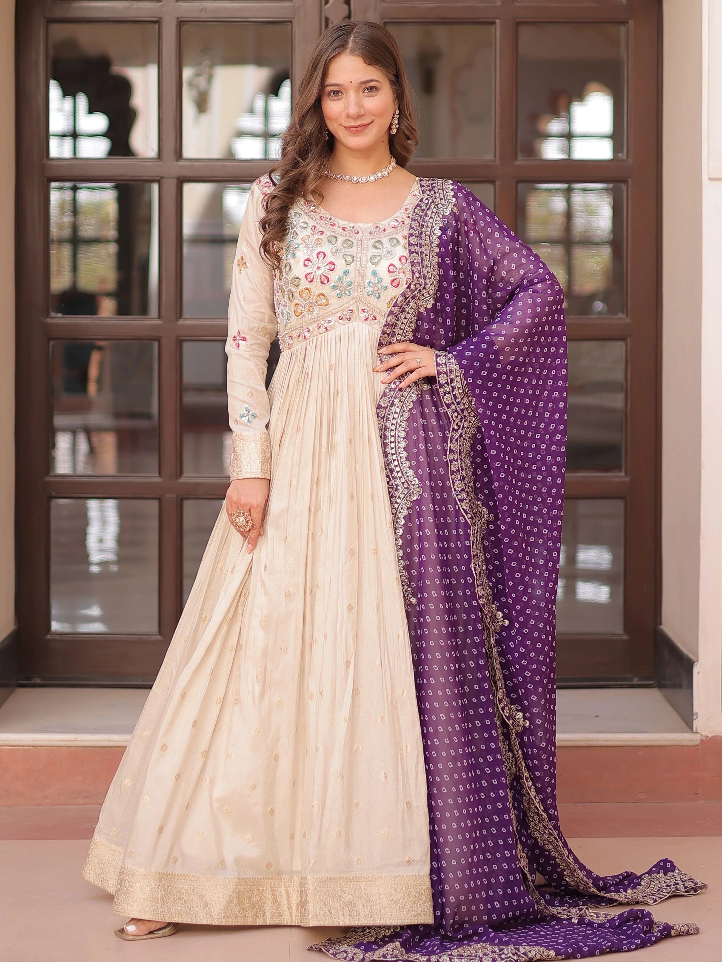Cream silk gown with pearl beads embroidery and purple bandhani dupatta