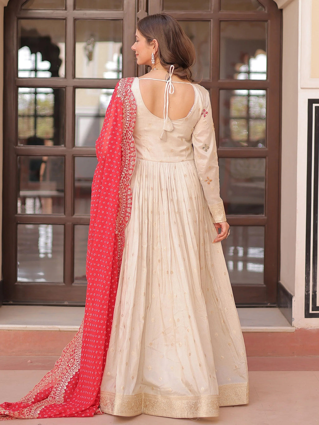 Cream silk gown with pearl beads embroidery and red bandhani dupatta