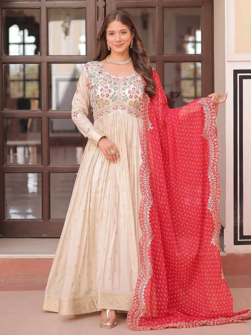 Cream silk gown with pearl beads embroidery and red bandhani dupatta