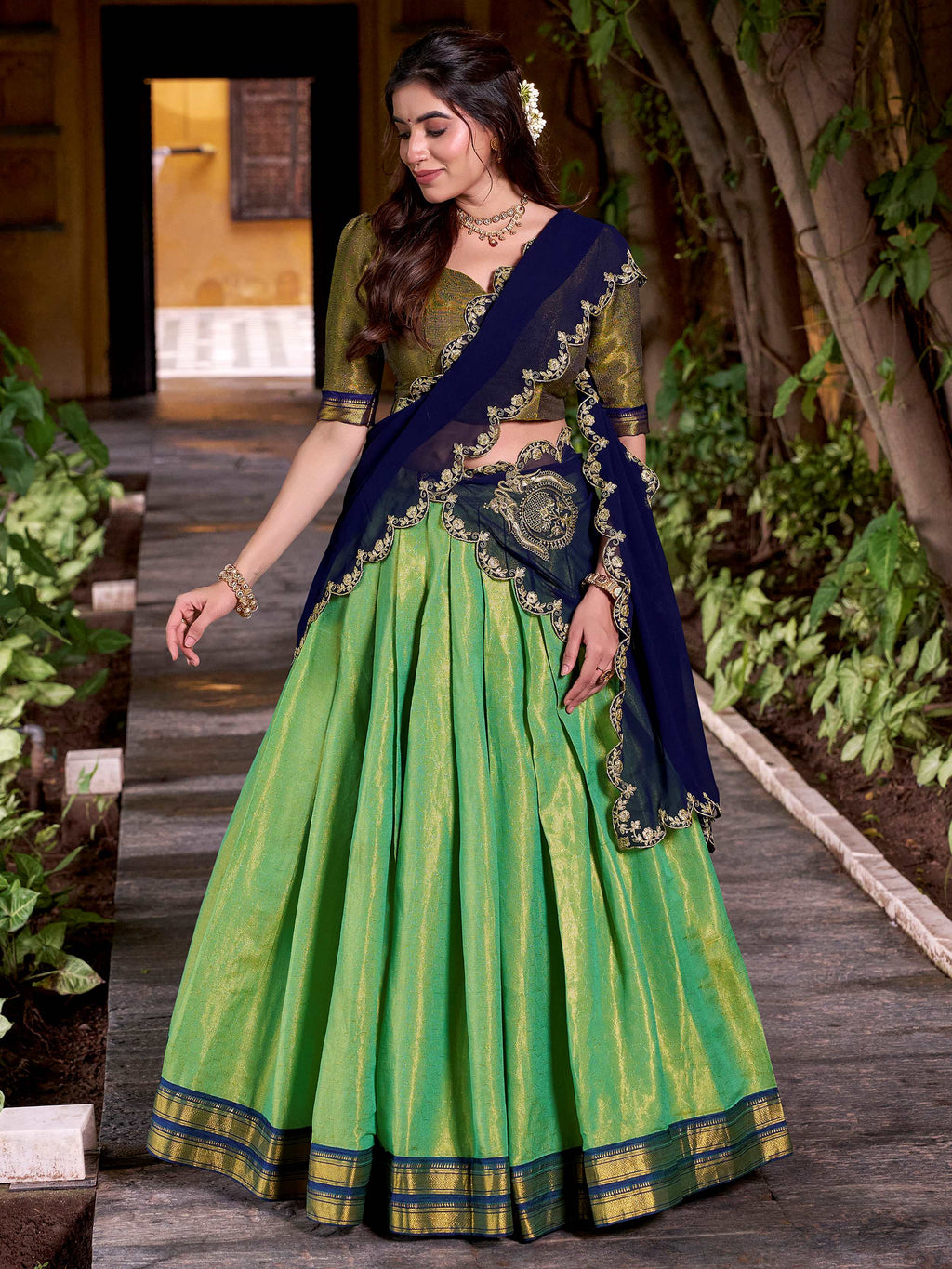 Green kanchipuram silk lehenga choli with zari weaving and sequins embroidery