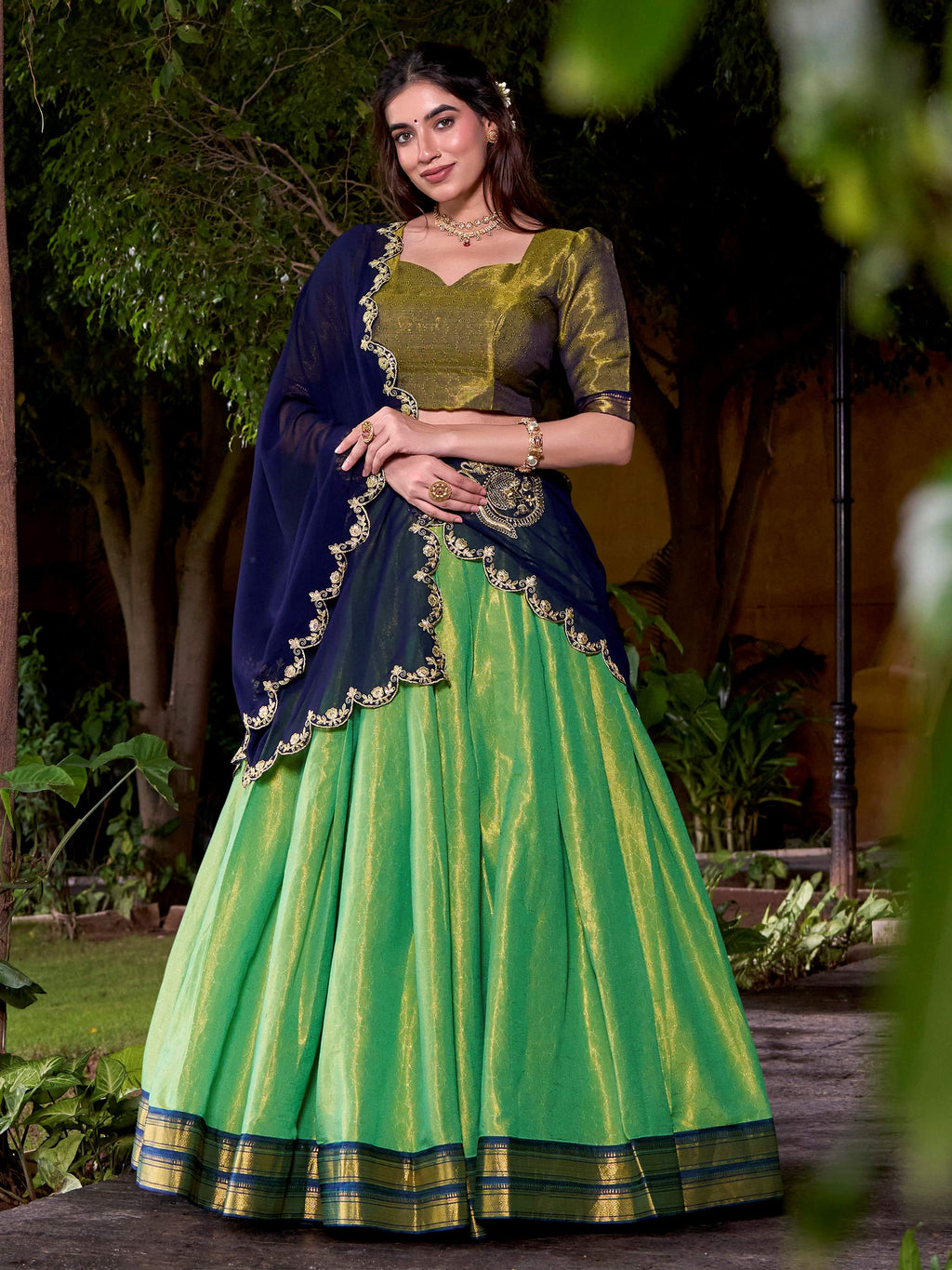 Green kanchipuram silk lehenga choli with zari weaving and sequins embroidery