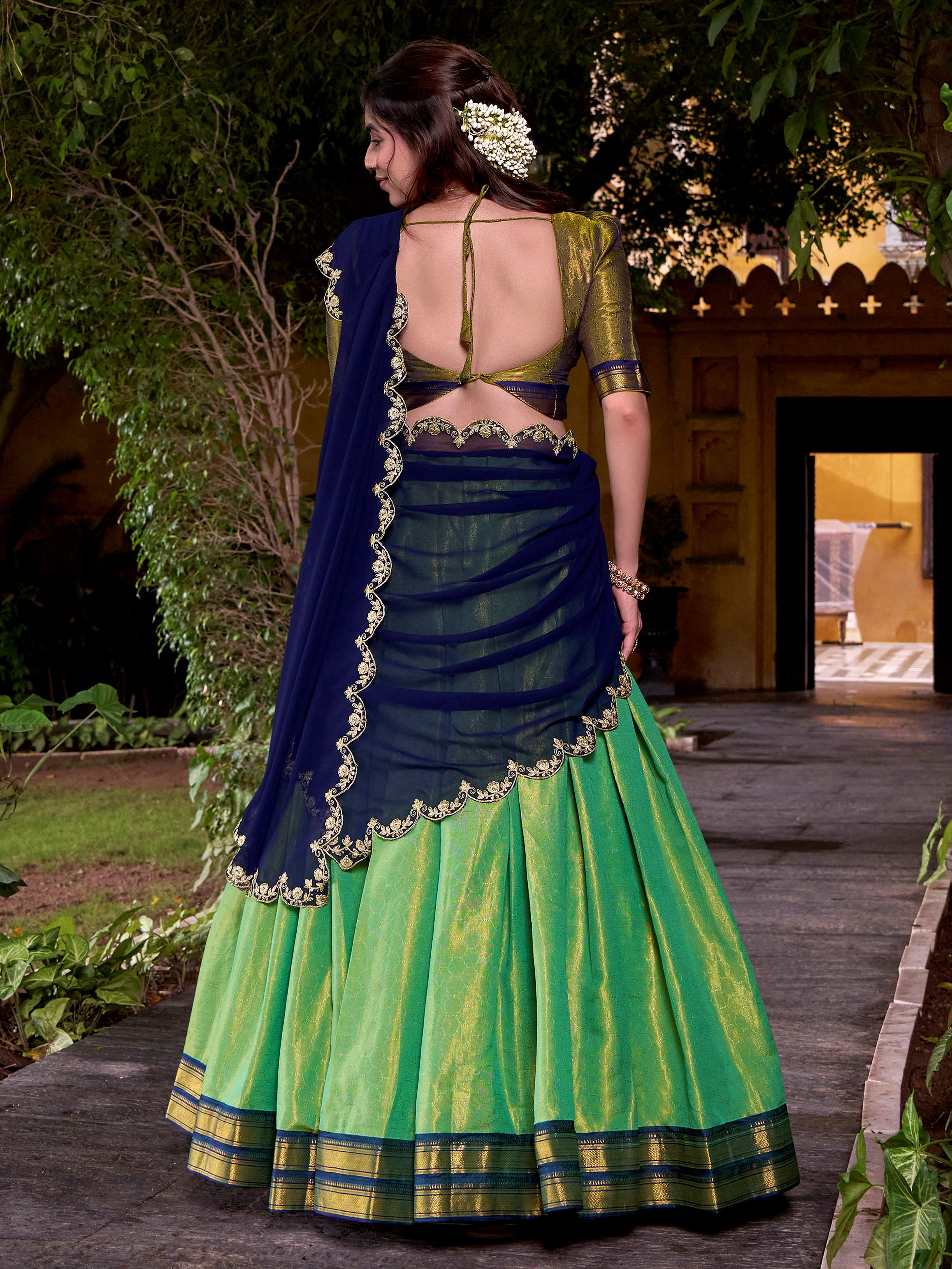 Green kanchipuram silk lehenga choli with zari weaving and sequins embroidery