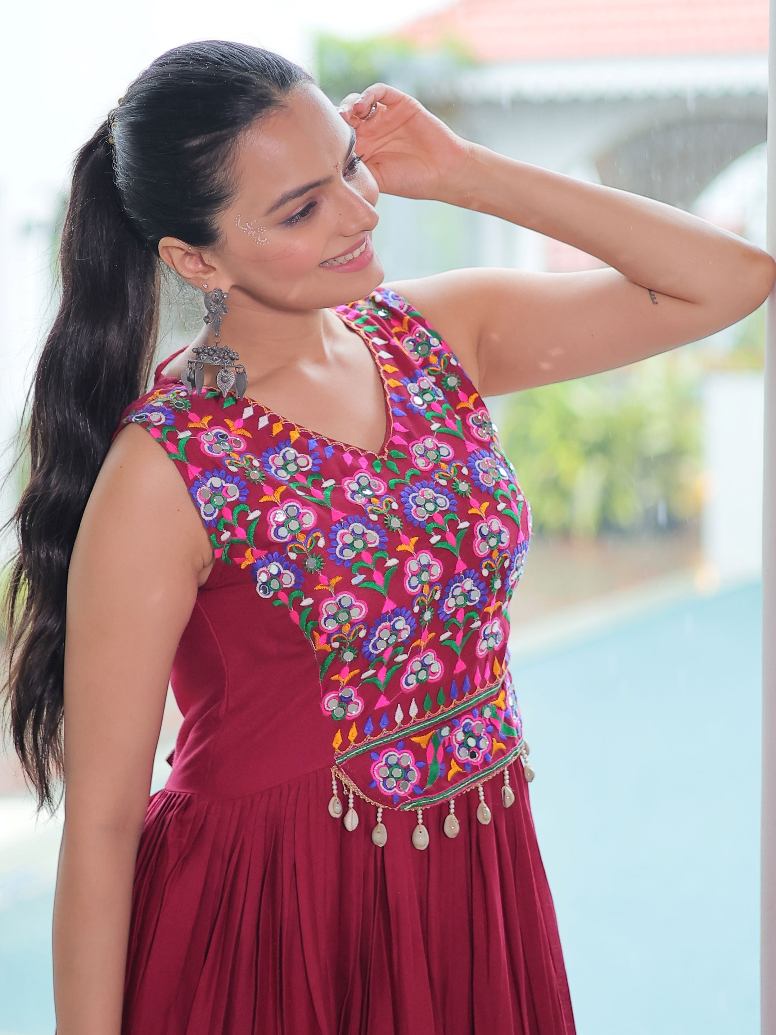 Maroon rayon sleeveless gown with kutchi gamthi embroidery and mirror work