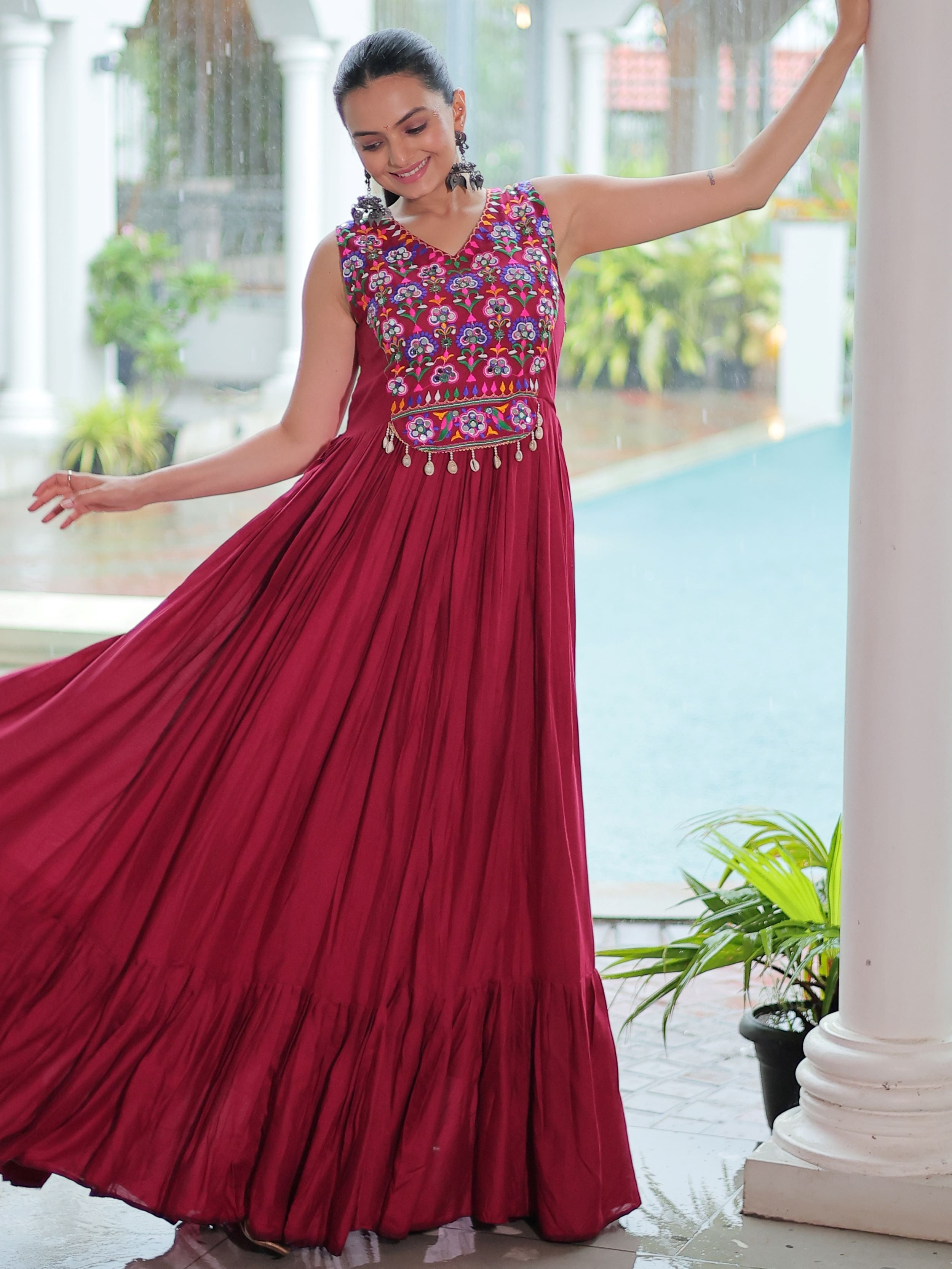 Maroon rayon sleeveless gown with kutchi gamthi embroidery and mirror work