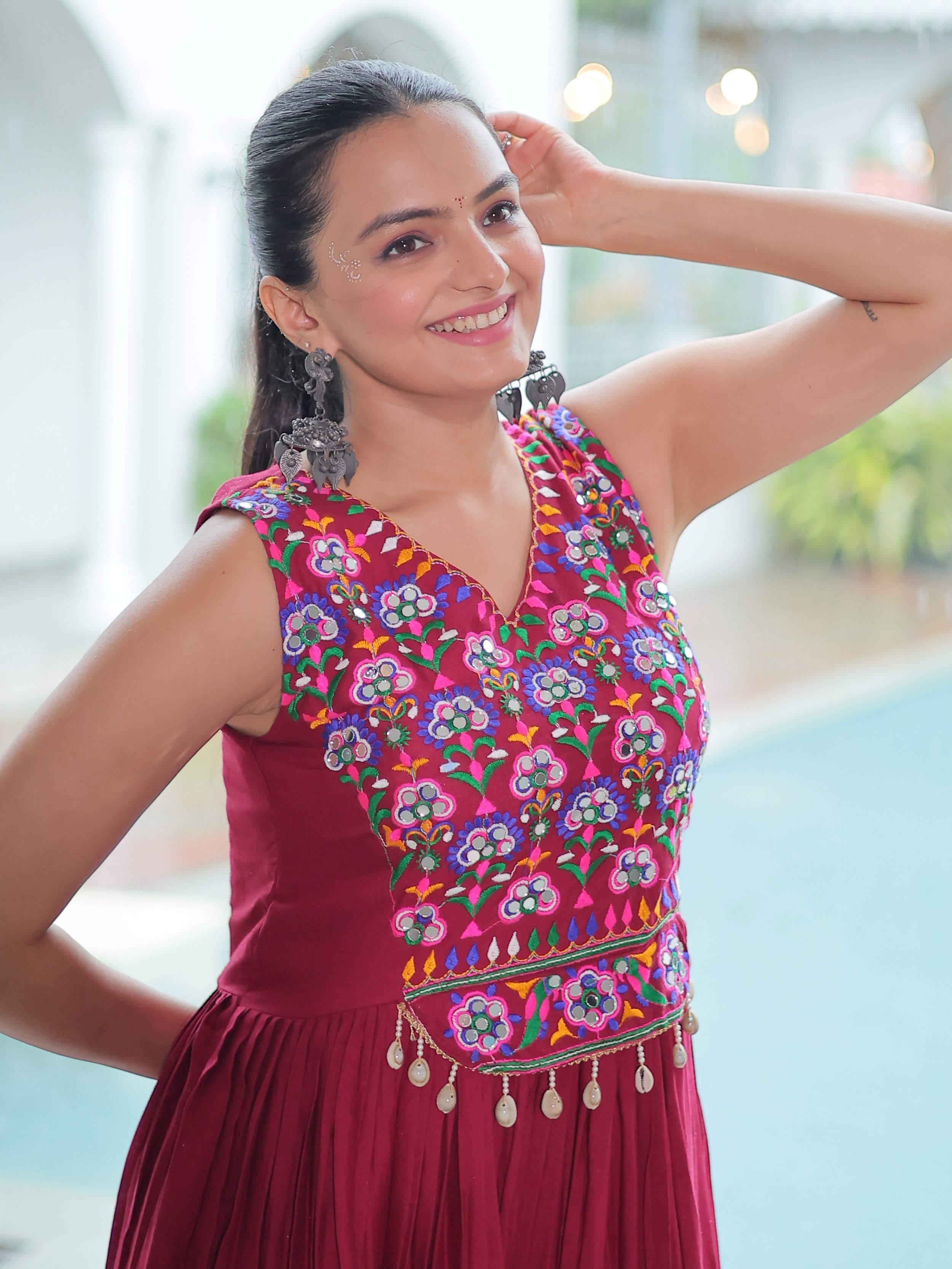 Maroon rayon sleeveless gown with kutchi gamthi embroidery and mirror work