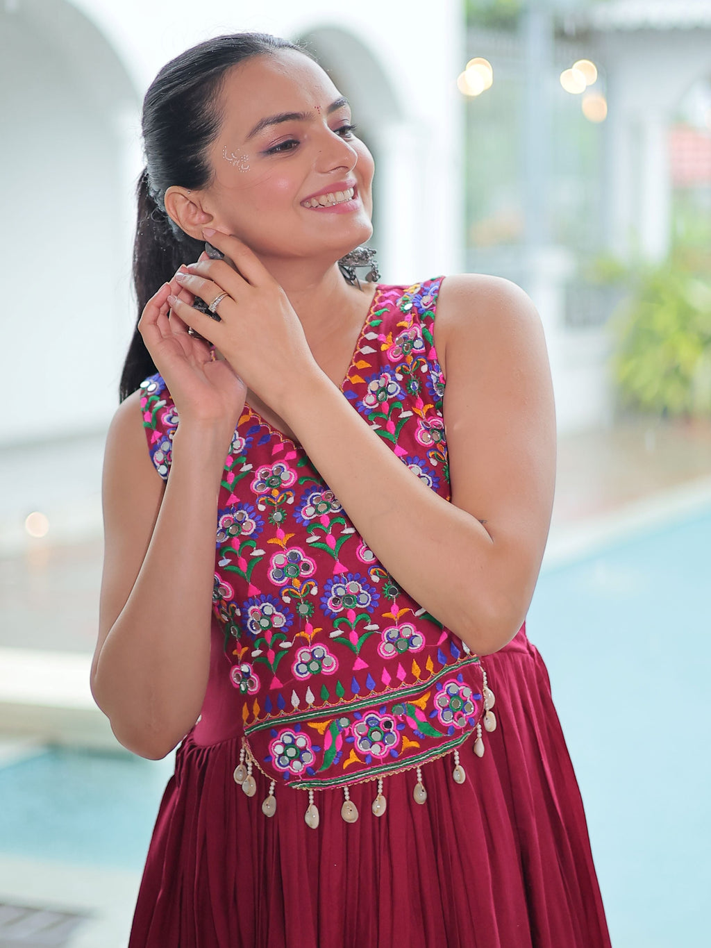 Maroon rayon sleeveless gown with kutchi gamthi embroidery and mirror work