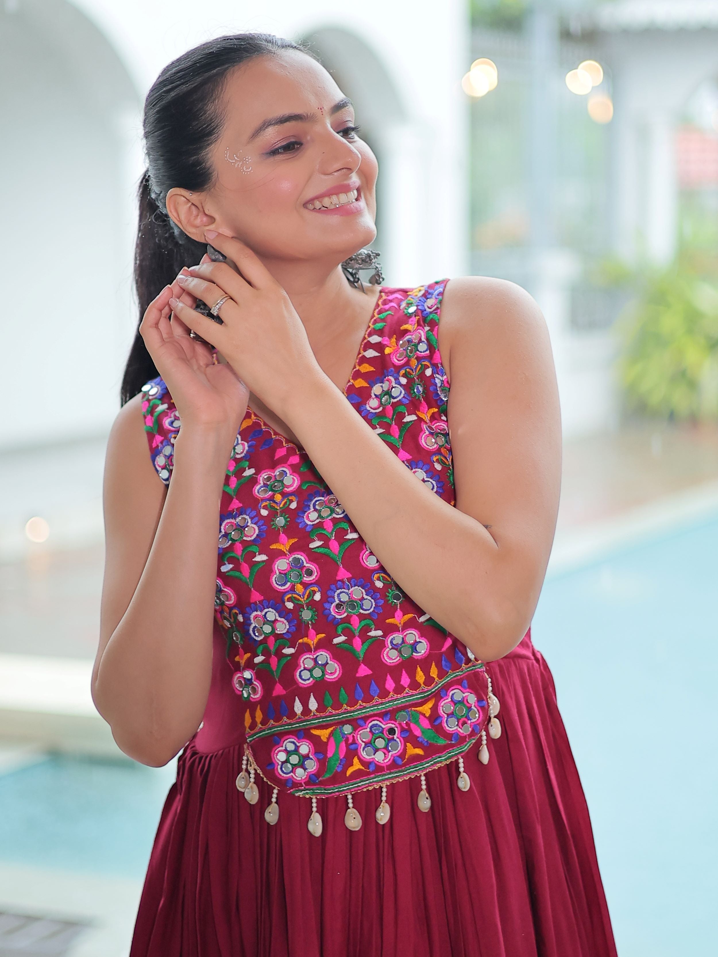 Maroon rayon sleeveless gown with kutchi gamthi embroidery and mirror work