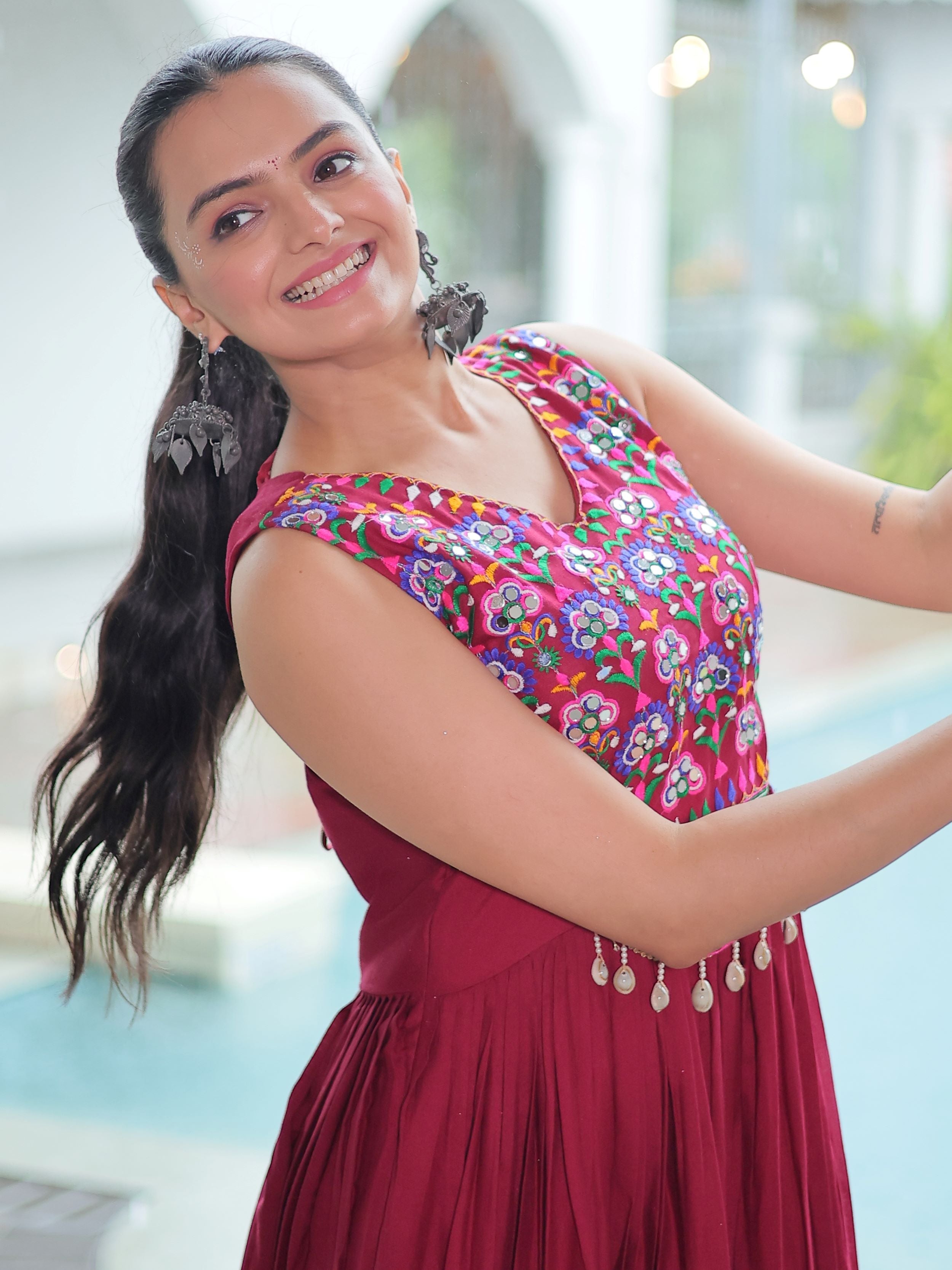 Maroon rayon sleeveless gown with kutchi gamthi embroidery and mirror work