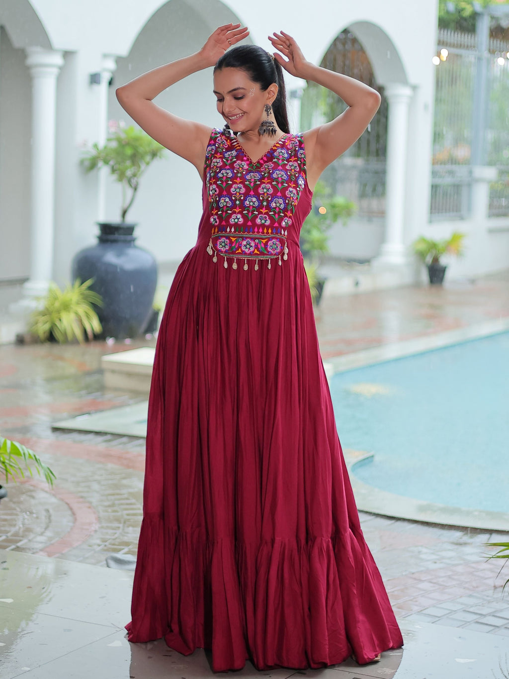 Maroon rayon sleeveless gown with kutchi gamthi embroidery and mirror work